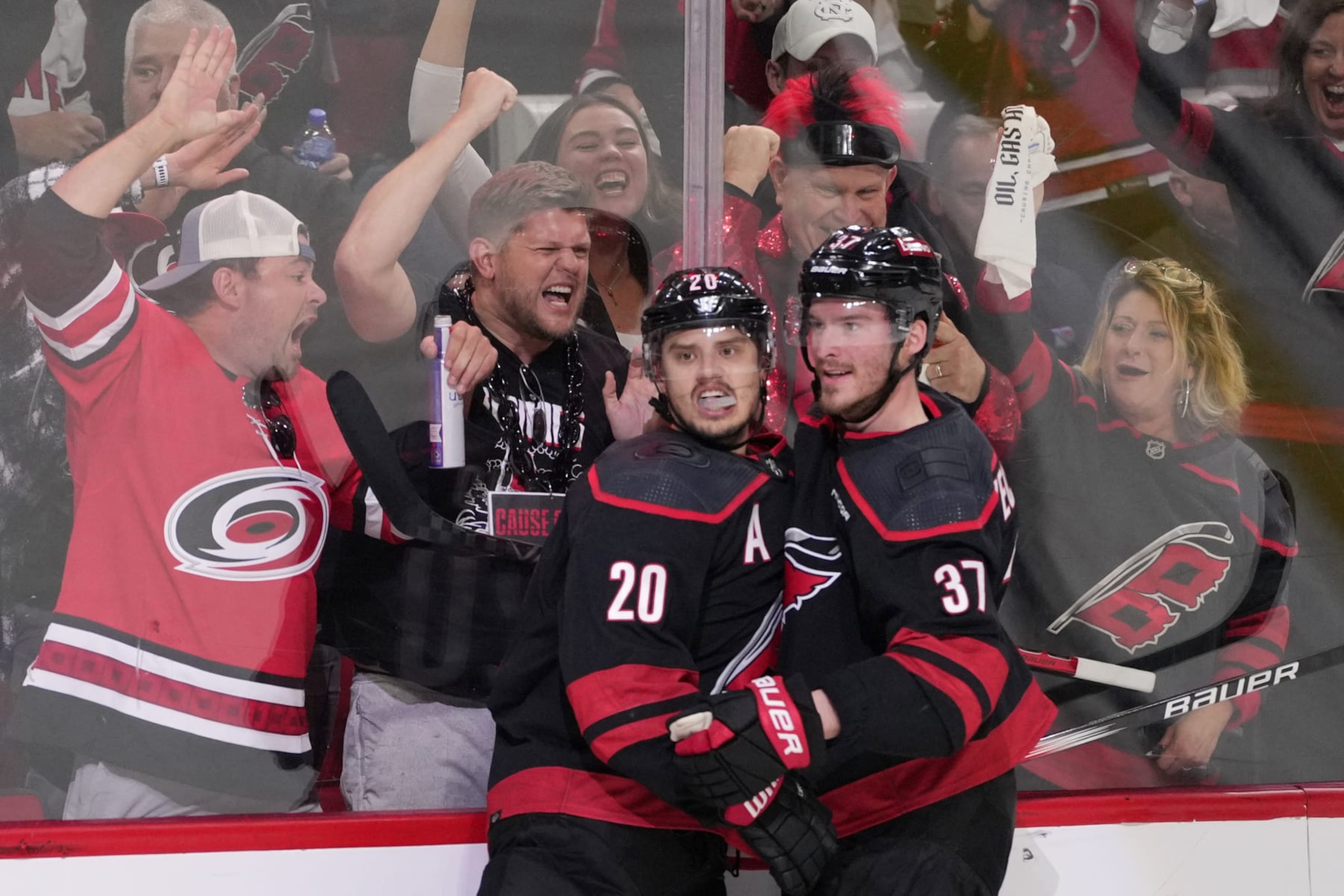 RALEIGH, NORTH CAROLINA - MAY 16: Sebastian Aho #20 of the Carolina Hurricanes is congratulated by teammate Andrei Svechnikov #37 of the Carolina Hurricanes after scoring a goal against the New York Rangers during the second period in Game Six of the Second Round of the 2024 Stanley Cup Playoffs at PNC Arena on May 16, 2024 in Raleigh, North Carolina.  (Photo by Grant Halverson/Getty Images)
