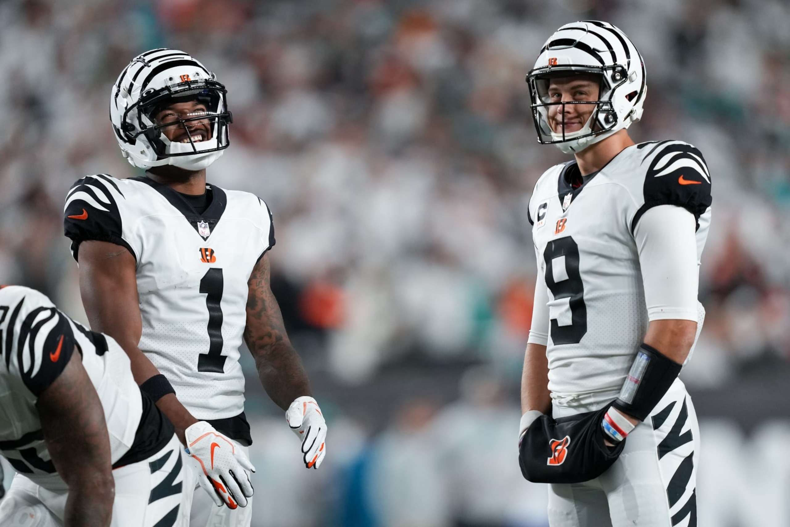 CINCINNATI, OHIO - SEPTEMBER 29: Ja'Marr Chase #1 and Joe Burrow #9 of the Cincinnati Bengals meet in the fourth quarter against the Miami Dolphins at Paycor Stadium on September 29, 2022 in Cincinnati, Ohio. (Photo by Dylan Buell/Getty Images)