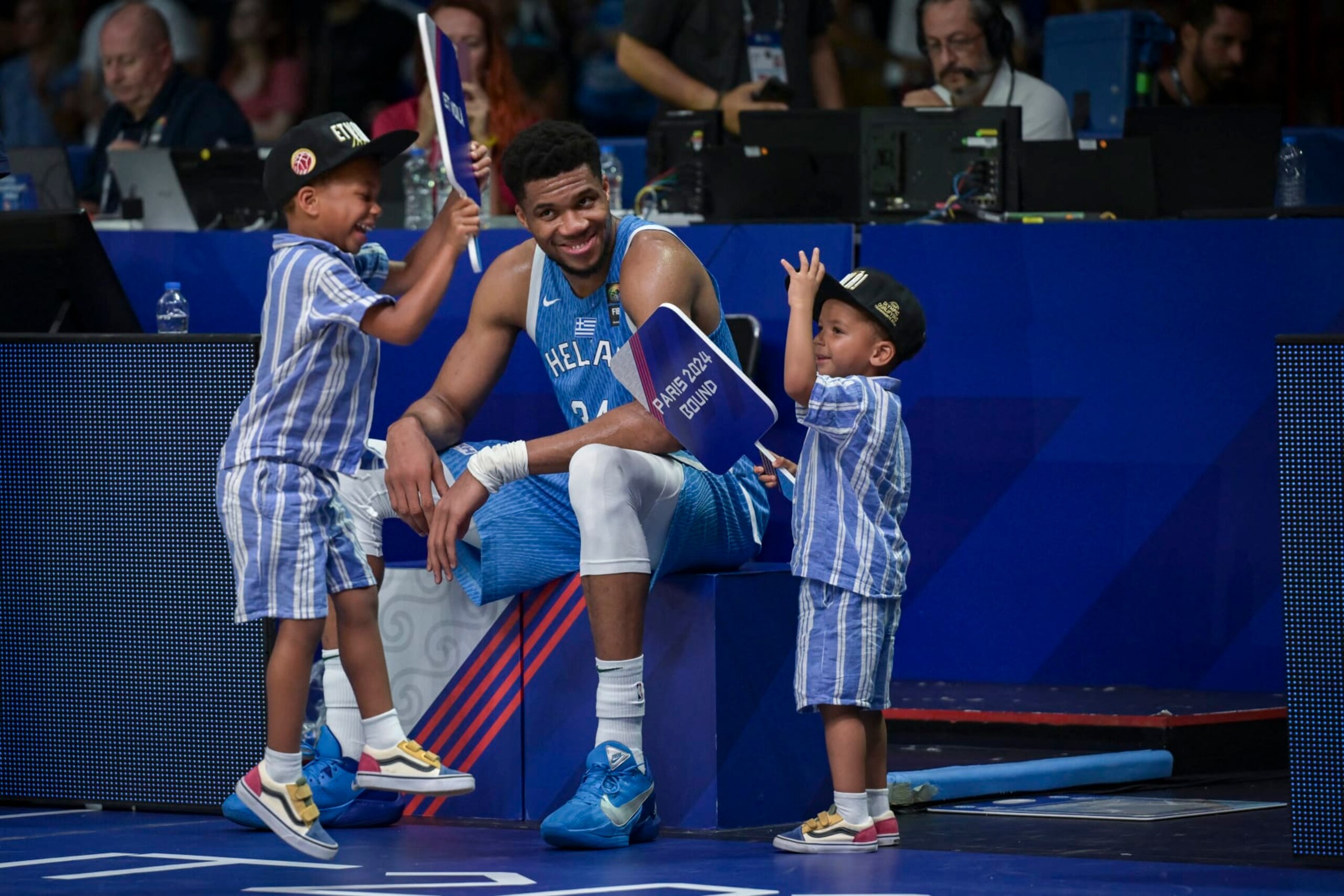 Greece's Giannis Antetokoumpo reacts with his children as he celebrates the win at the end of the final game of the FIBA Olympic Qualifying Tournament between Croatia and Greece to be qualified for the Paris 2024 Olympics and Paralympics games, at the Peace and Friendship Stadium in Athens on July 7, 2024. (Photo by Aris MESSINIS / AFP) (Photo by ARIS MESSINIS/AFP via Getty Images)