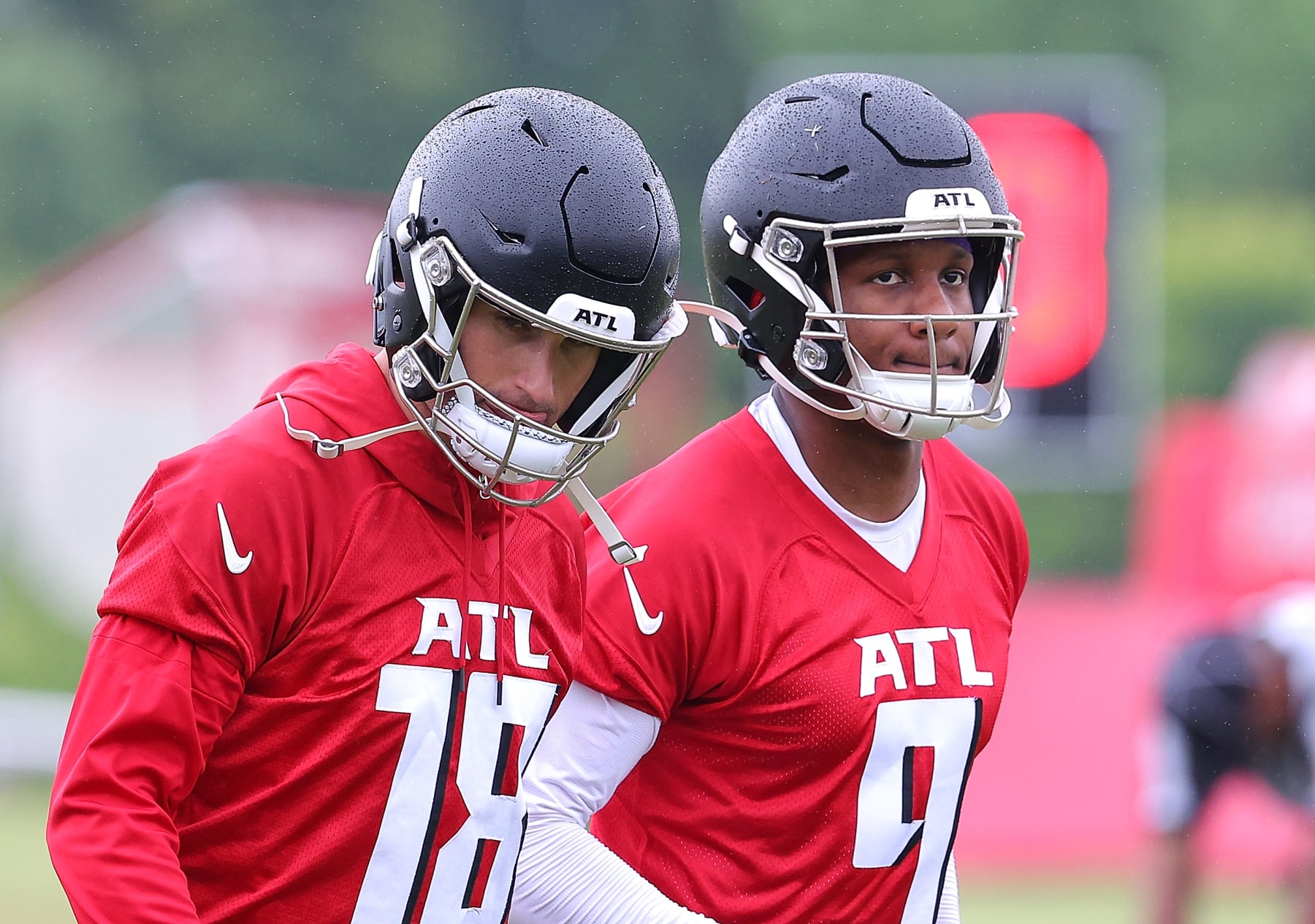 FLOWERY BRANCH, GEORGIA - MAY 14:  Quarterbacks Kirk Cousins #18 and Michael Penix Jr. #9 of the Atlanta Falcons look on during OTA offseason workouts at the Atlanta Falcons training facility on May 14, 2024 in Flowery Branch, Georgia. (Photo by Kevin C. Cox/Getty Images)