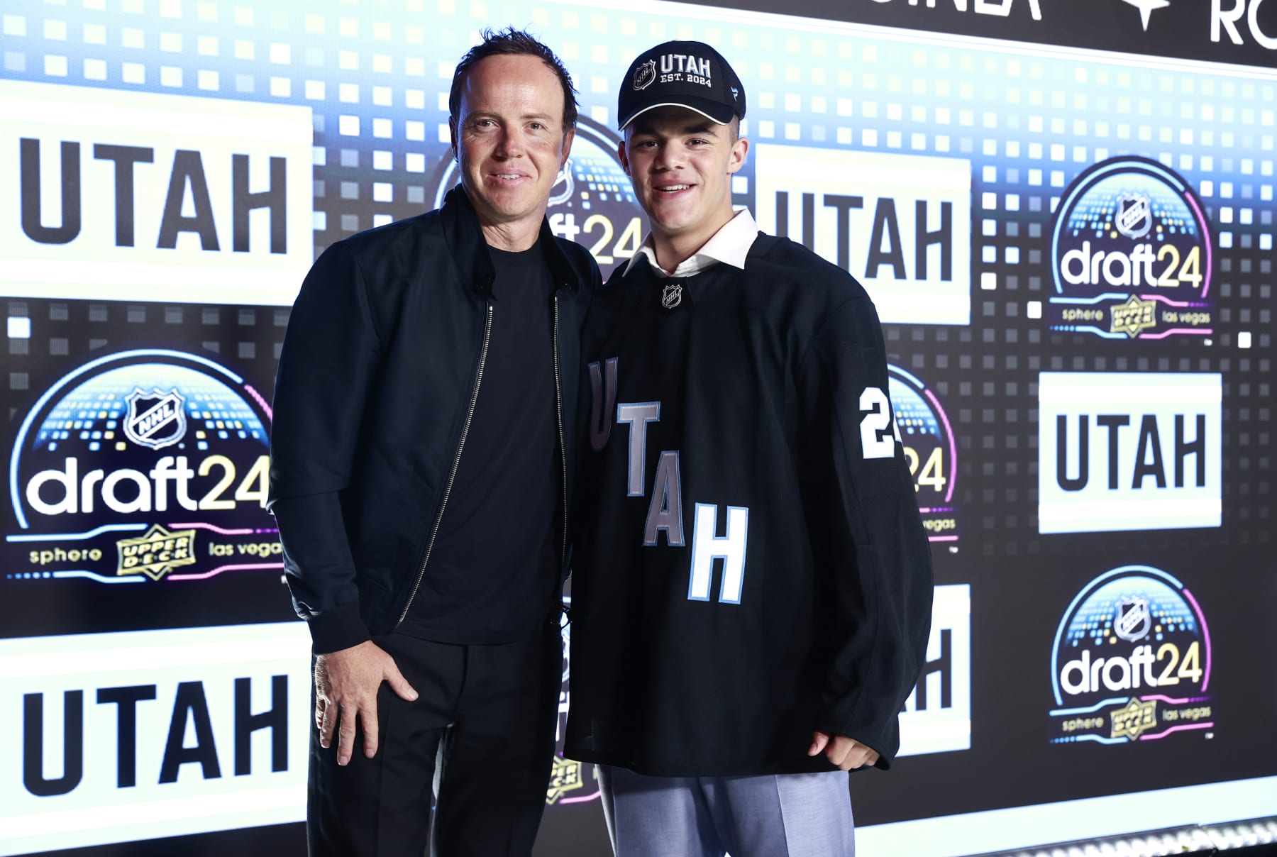 Utah owner Ryan Smith and 2024 first-round pick Tij Iginla 