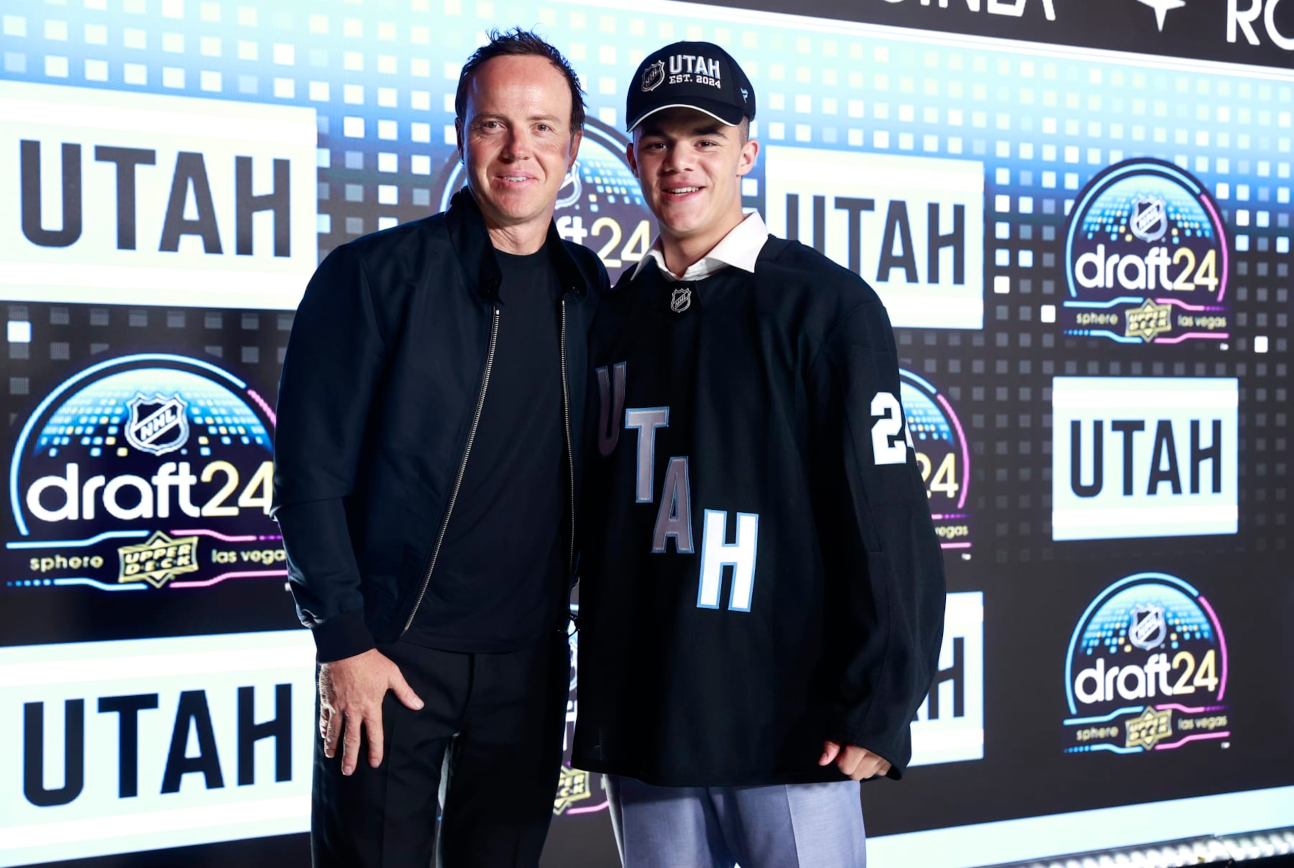 Utah owner Ryan Smith and 2024 first-round pick Tij Iginla 