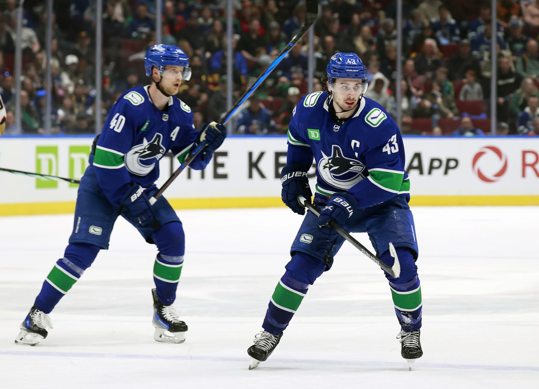 VANCOUVER, CANADA - MARCH 31: Quinn Hughes #43 and Elias Pettersson #40 of the Vancouver Canucks skate up ice during their NHL game against the Anaheim Ducks at Rogers Arena on March 31, 2024 in Vancouver, British Columbia, Canada.  (Photo by Jeff Vinnick/NHLI via Getty Images)