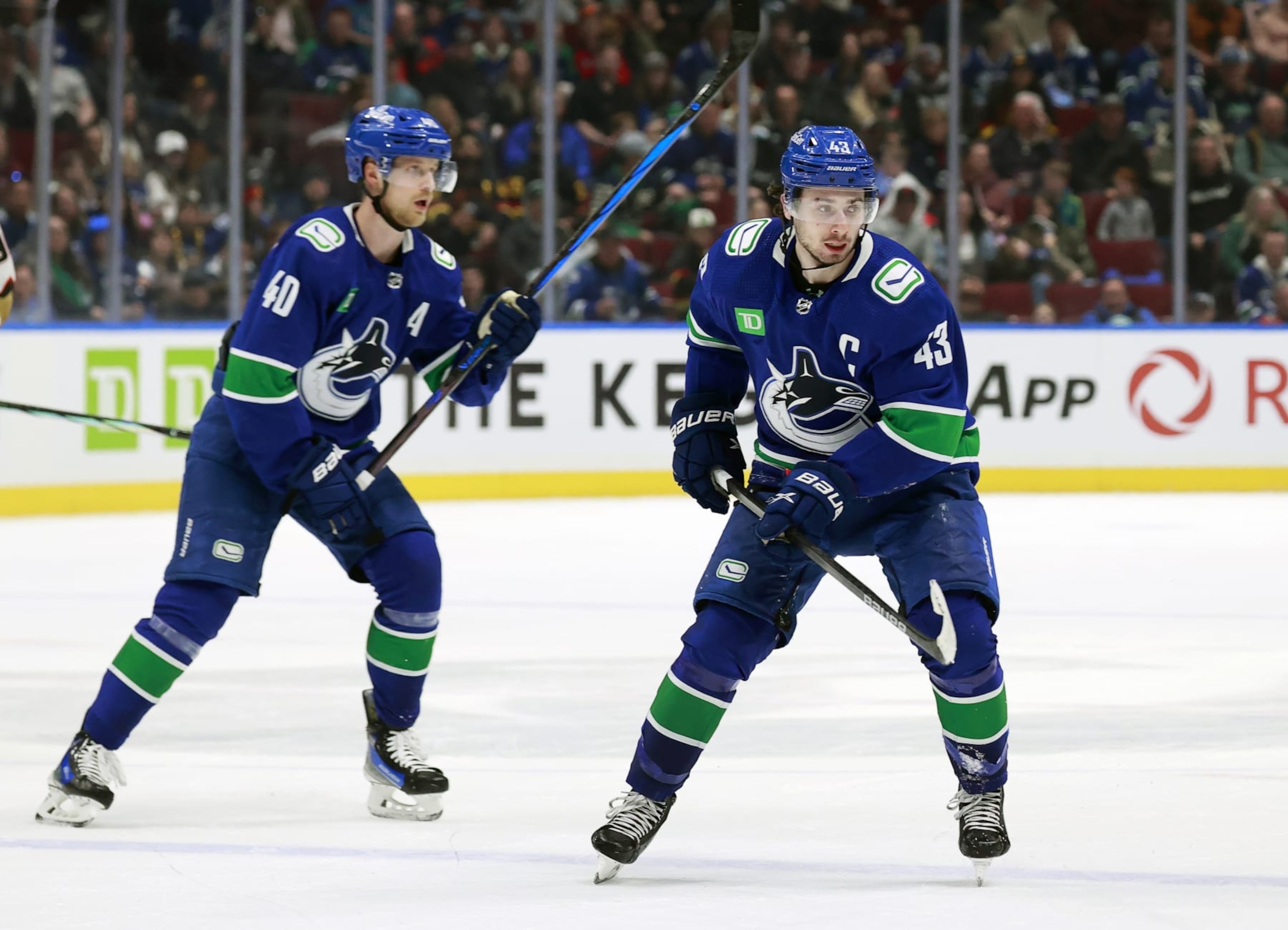 VANCOUVER, CANADA - MARCH 31: Quinn Hughes #43 and Elias Pettersson #40 of the Vancouver Canucks skate up ice during their NHL game against the Anaheim Ducks at Rogers Arena on March 31, 2024 in Vancouver, British Columbia, Canada.  (Photo by Jeff Vinnick/NHLI via Getty Images)
