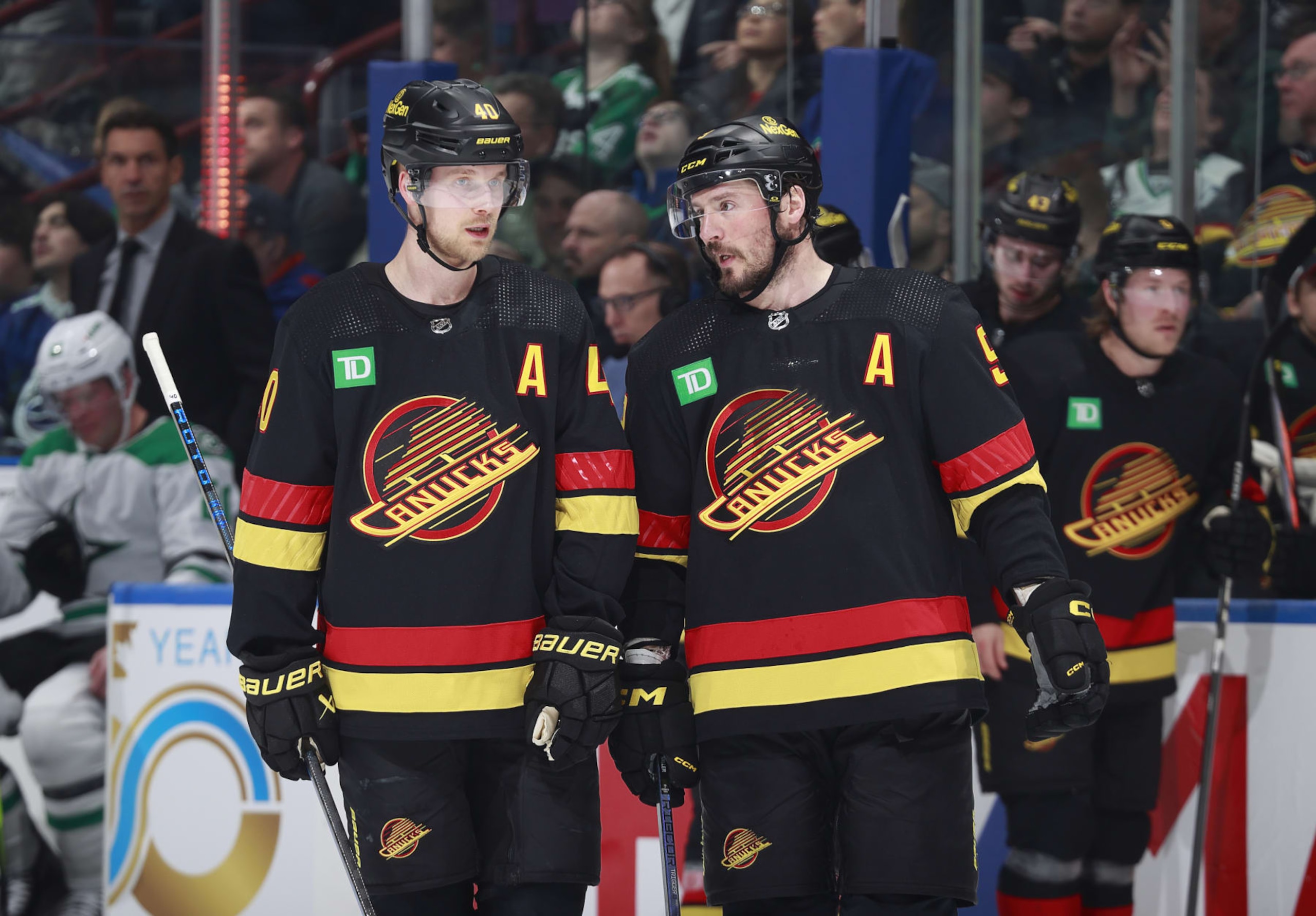 VANCOUVER, CANADA - MARCH 28: J.T. Miller #9 of the Vancouver Canucks talks to teammate Elias Pettersson #40 during their NHL game against the Dallas Stars at Rogers Arena on March 28, 2024 in Vancouver, British Columbia, Canada.  (Photo by Jeff Vinnick/NHLI via Getty Images)