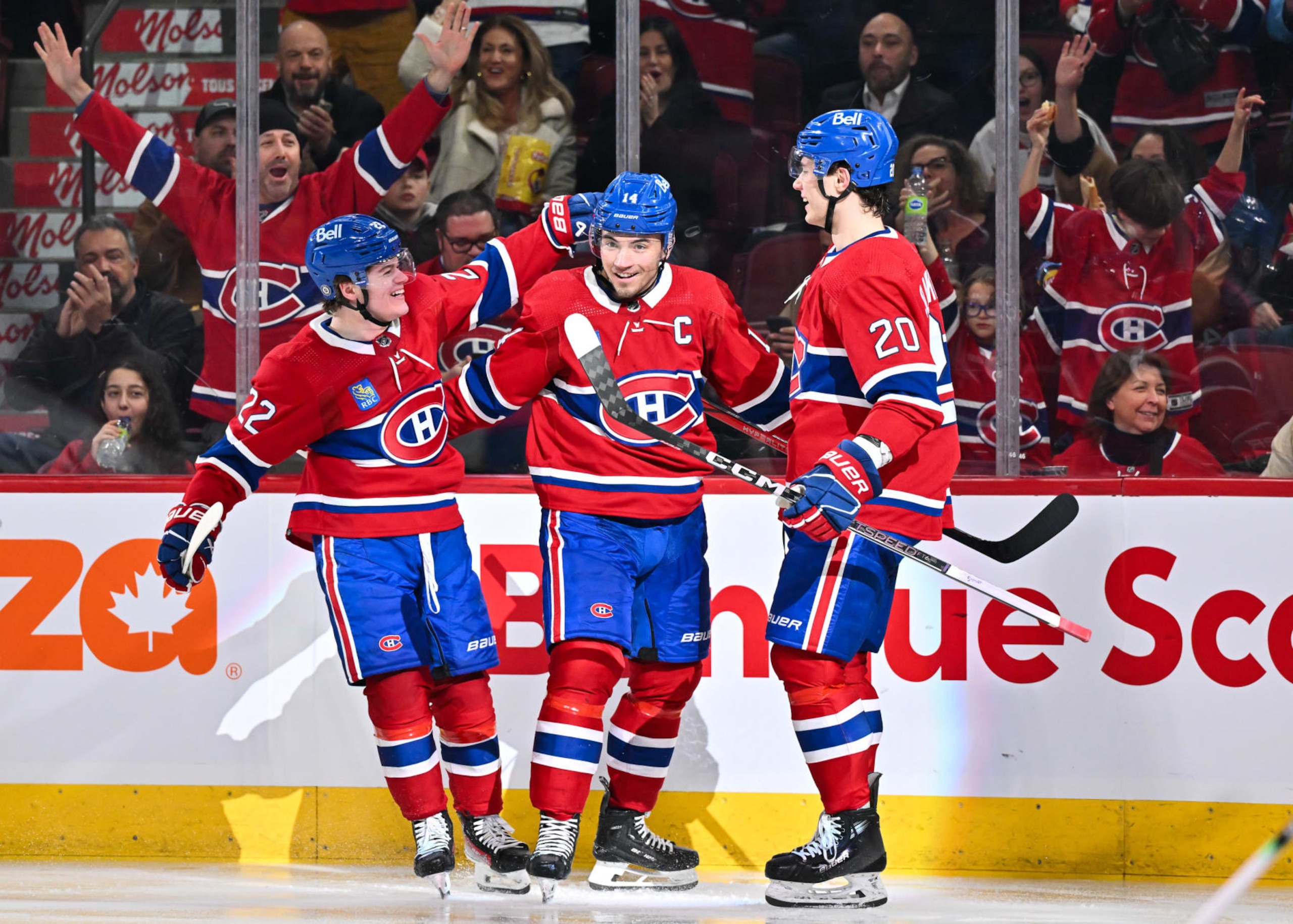 MONTREAL, CANADA - FEBRUARY 10:  Nick Suzuki #14 of the Montreal Canadiens celebrates his goal with teammates Cole Caufield #22 and Juraj Slafkovsky #20 during the second period against the Dallas Stars at the Bell Centre on February 10, 2024 in Montreal, Quebec, Canada.  (Photo by Minas Panagiotakis/Getty Images)