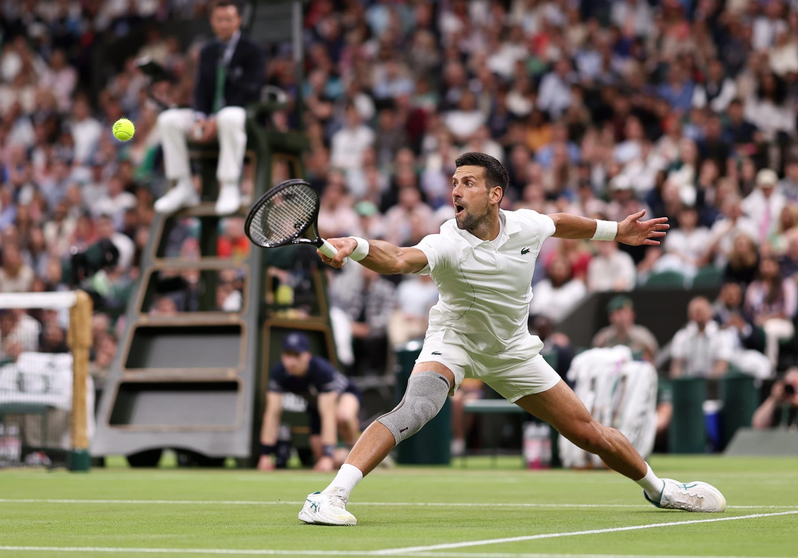 LONDON, ENGLAND - JULY 08: Novak Djokovic of Serbia plays a backhand against Holger Rune of Denmark in his Gentlemen's Singles fourth round match during day eight of The Championships Wimbledon 2024 at All England Lawn Tennis and Croquet Club on July 08, 2024 in London, England. (Photo by Julian Finney/Getty Images)