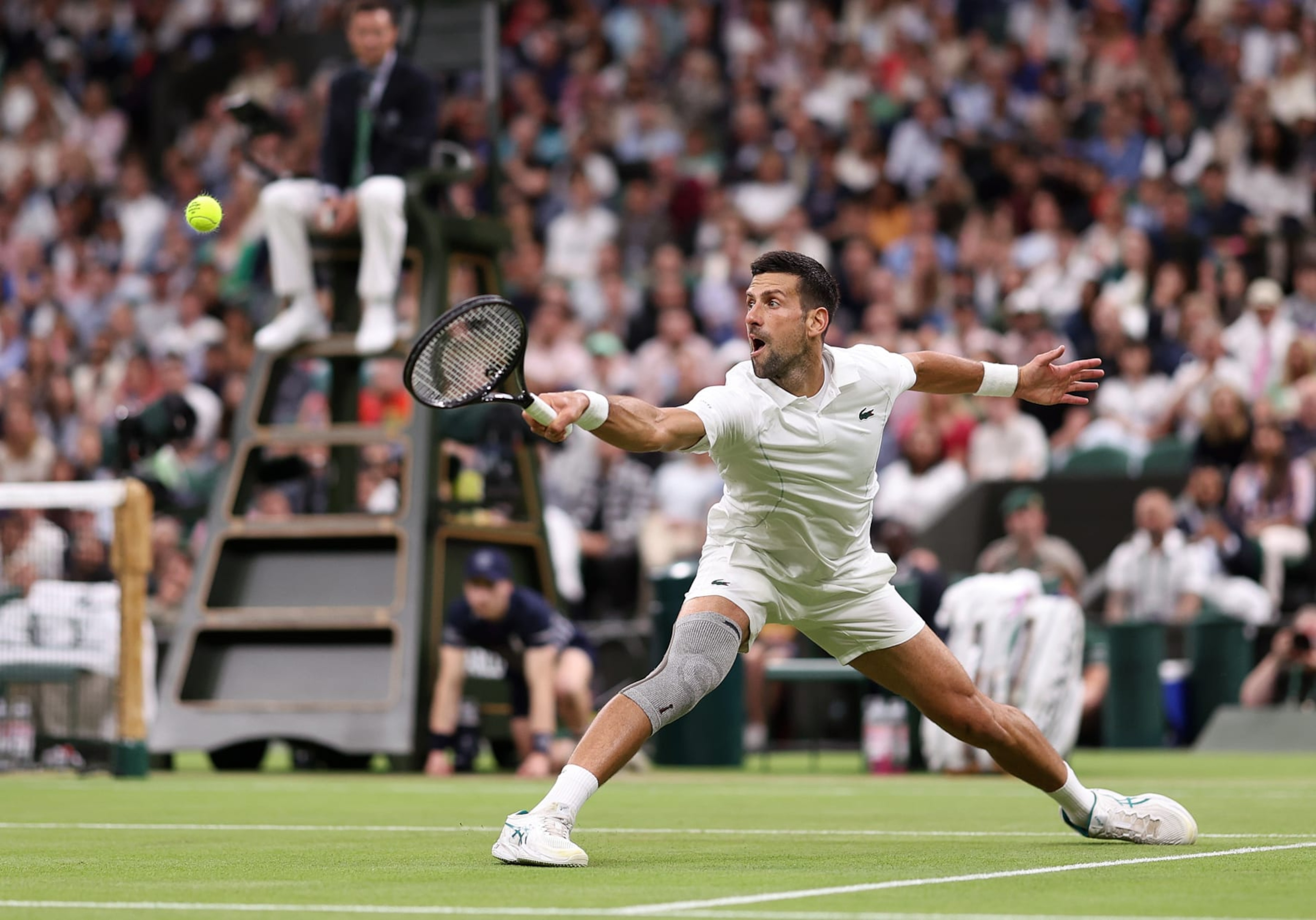 LONDON, ENGLAND - JULY 08: Novak Djokovic of Serbia plays a backhand against Holger Rune of Denmark in his Gentlemen's Singles fourth round match during day eight of The Championships Wimbledon 2024 at All England Lawn Tennis and Croquet Club on July 08, 2024 in London, England. (Photo by Julian Finney/Getty Images) LONDON, ENGLAND - JULY 08: Novak Djokovic of Serbia plays a backhand against Holger Rune of Denmark in his Gentlemen's Singles fourth round match during day eight of The Championships Wimbledon 2024 at All England Lawn Tennis and Croquet Club on July 08, 2024 in London, England. (Photo by Julian Finney/Getty Images)