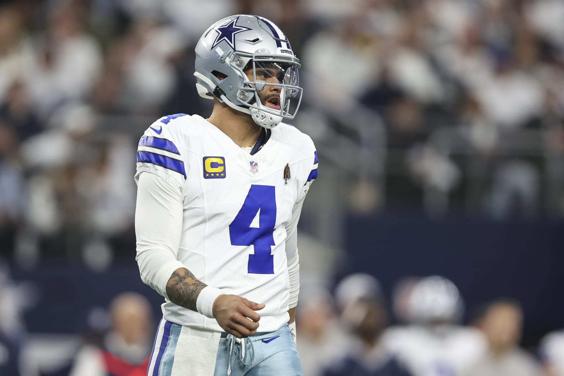 ARLINGTON, TX - JANUARY 14: Dak Prescott #4 of the Dallas Cowboys looks on from the field during an NFL wild-card playoff football game against the Green Bay Packers at AT&T Stadium on January 14, 2024 in Arlington, Texas. (Photo by Perry Knotts/Getty Images)