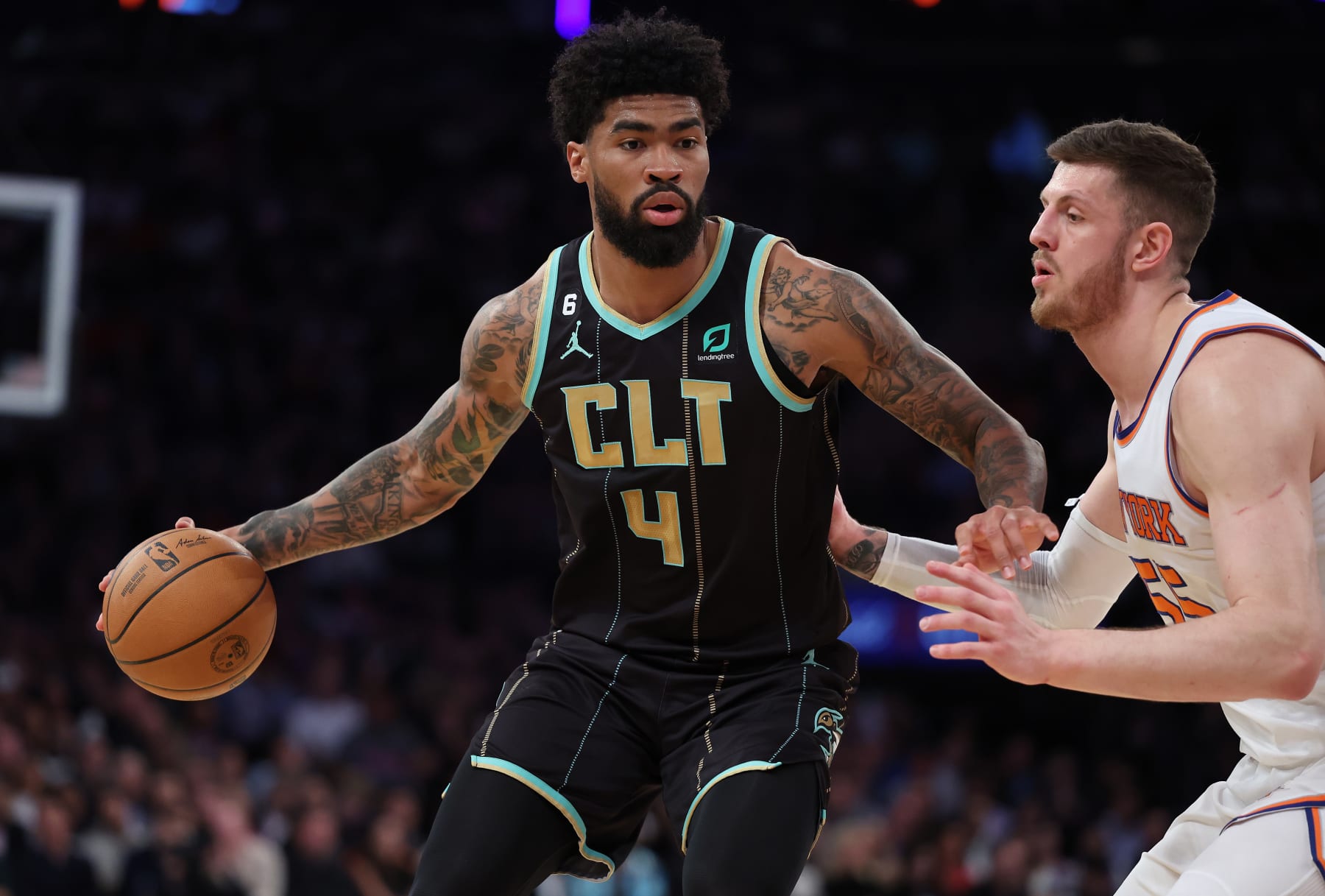 NEW YORK, NEW YORK - MARCH 07:  Nick Richards #4 of the Charlotte Hornets dribbles against Isaiah Hartenstein #55 of the New York Knicks	during their game at Madison Square Garden on March 07, 2023 in New York City.  User expressly acknowledges and agrees that, by downloading and or using this photograph, User is consenting to the terms and conditions of the Getty Images License Agreement.   (Photo by Al Bello/Getty Images)