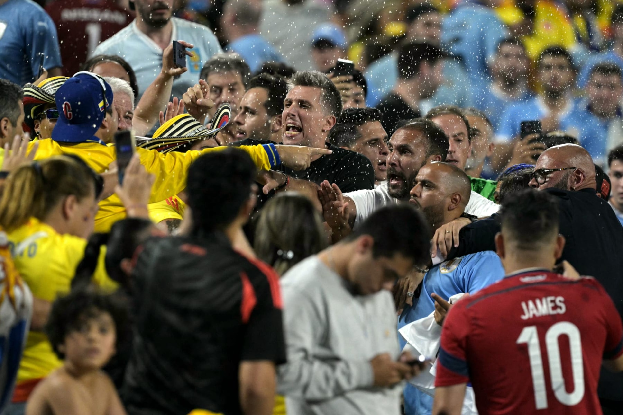Colombia's supporters (L) clash with Uruguay's supporters at the end of the Conmebol 2024 Copa America tournament semi-final football match between Uruguay and Colombia at Bank of America Stadium, in Charlotte, North Caroline on July 10, 2024. (Photo by JUAN MABROMATA / AFP) (Photo by JUAN MABROMATA/AFP via Getty Images)