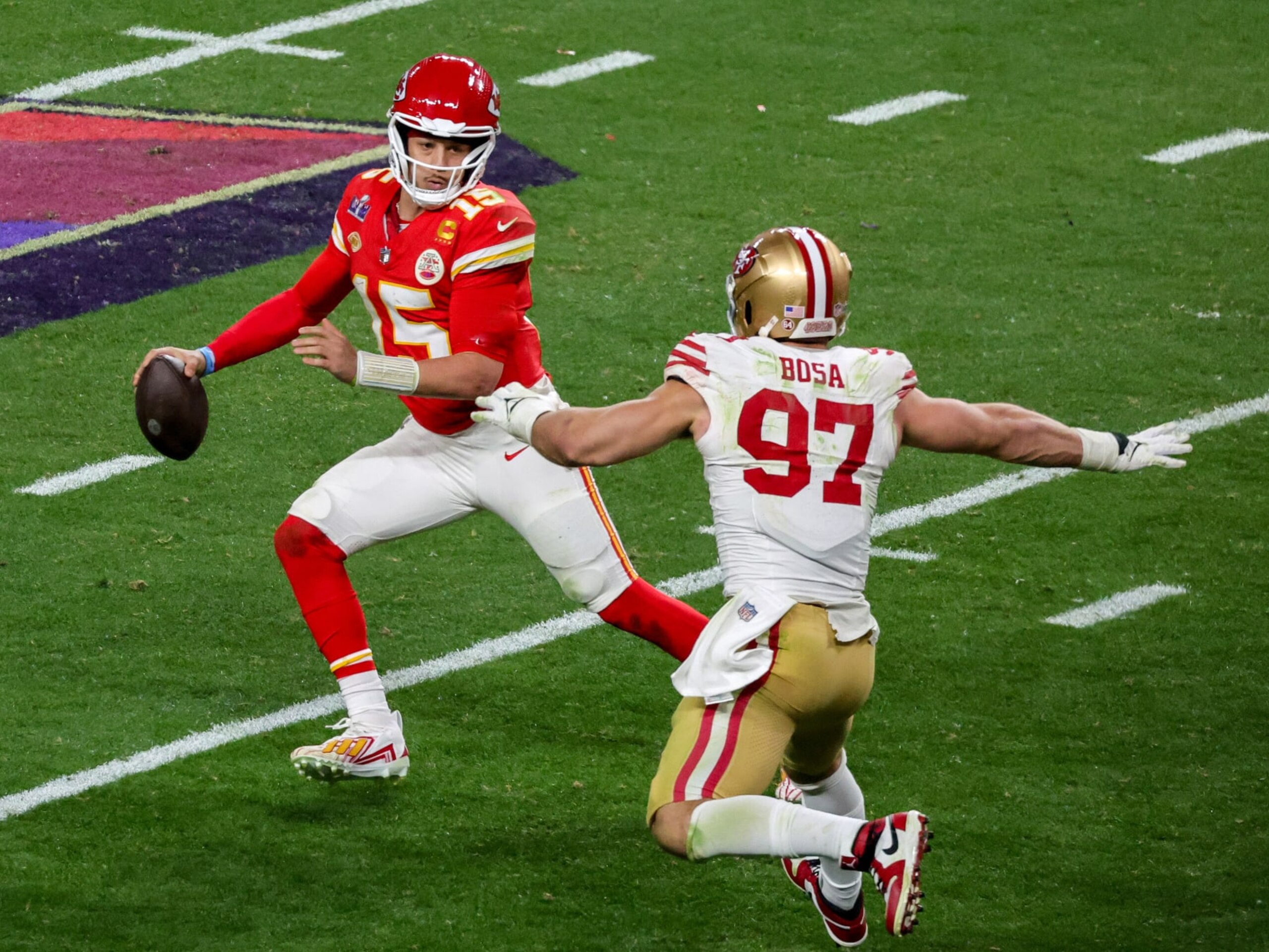 LAS VEGAS, NEVADA - FEBRUARY 11: Quarterback Patrick Mahomes #15 of the Kansas City Chiefs looks to throw under pressure from defensive end Nick Bosa #97 of the San Francisco 49ers in the fourth quarter of Super Bowl LVIII at Allegiant Stadium on February 11, 2024 in Las Vegas, Nevada. The Chiefs defeated the 49ers 25-22 in overtime. (Photo by Ethan Miller/Getty Images)
