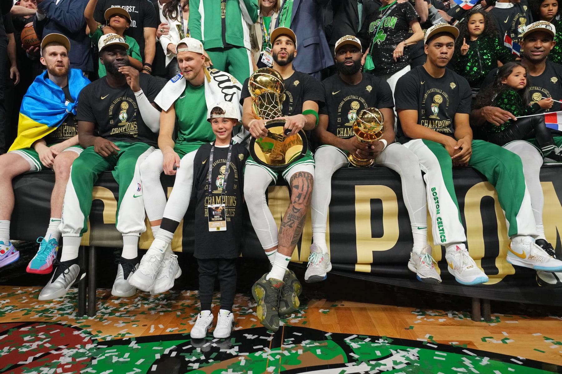 BOSTON, MA - JUNE 17: Svi Mykhailiuk #50, Neemias Queta #88, Kristaps Porzingis #8, Deuce Tatum, Jayson Tatum #0, Jaylen Brown #7, Jaden Springer #44 and Al Horford #42 of the Boston Celtics celebrate with the Larry O'Brien Trophy and The Bill Russell Finals MVP Trophy after the game against the Dallas Mavericks during Game 5 of the 2024 NBA Finals on June 17, 2024 at the TD Garden in Boston, Massachusetts. NOTE TO USER: User expressly acknowledges and agrees that, by downloading and or using this photograph, User is consenting to the terms and conditions of the Getty Images License Agreement. Mandatory Copyright Notice: Copyright 2024 NBAE  (Photo by Jesse D. Garrabrant/NBAE via Getty Images)