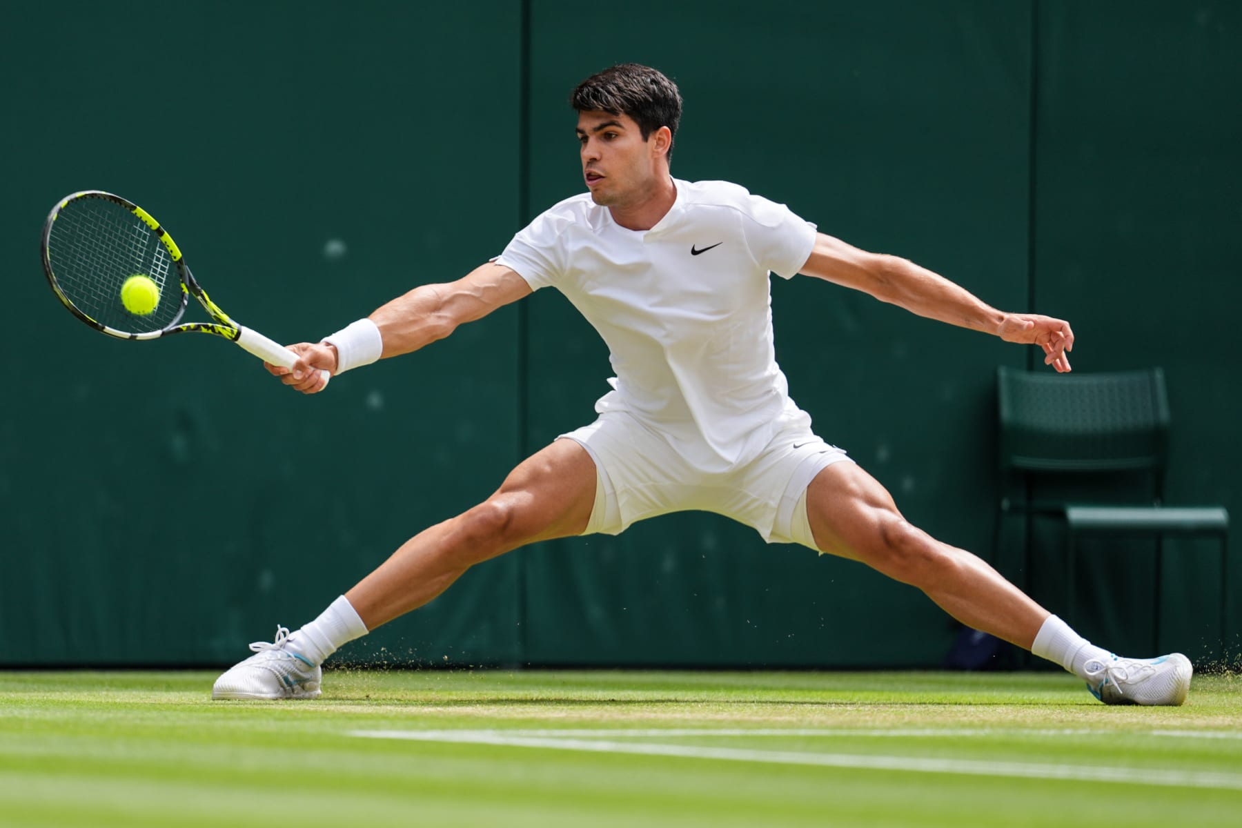 LONDON, ENGLAND - JULY 12: Carlos Alcaraz of Spain plays a forehand in the Men's Singles semi finals match against Daniil Medvedev during day twelve of The Championships Wimbledon 2024 at All England Lawn Tennis and Croquet Club on July 12, 2024 in London, England. (Photo by Shi Tang/Getty Images)