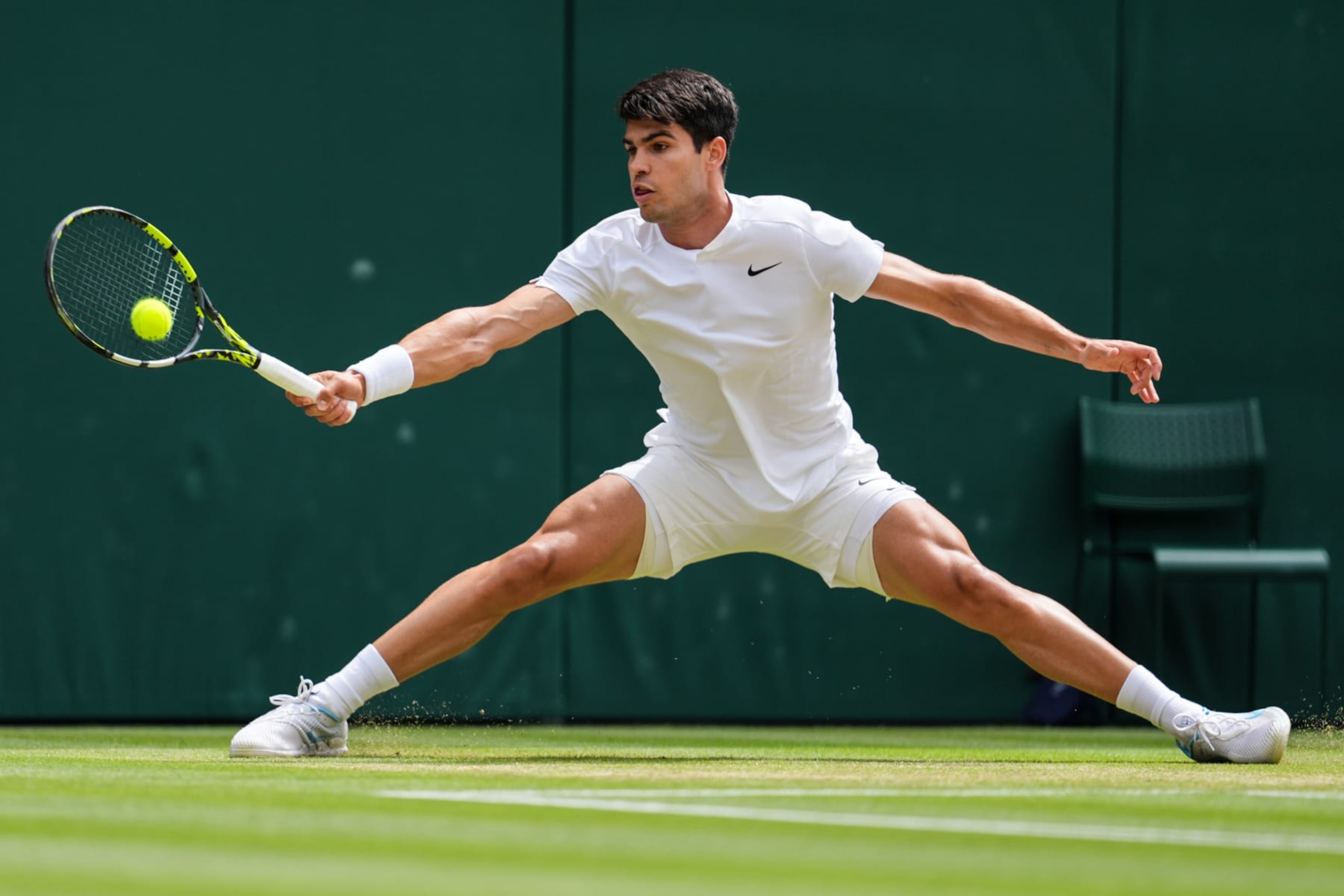 LONDON, ENGLAND - JULY 12: Carlos Alcaraz of Spain plays a forehand in the Men's Singles semi finals match against Daniil Medvedev during day twelve of The Championships Wimbledon 2024 at All England Lawn Tennis and Croquet Club on July 12, 2024 in London, England. (Photo by Shi Tang/Getty Images)