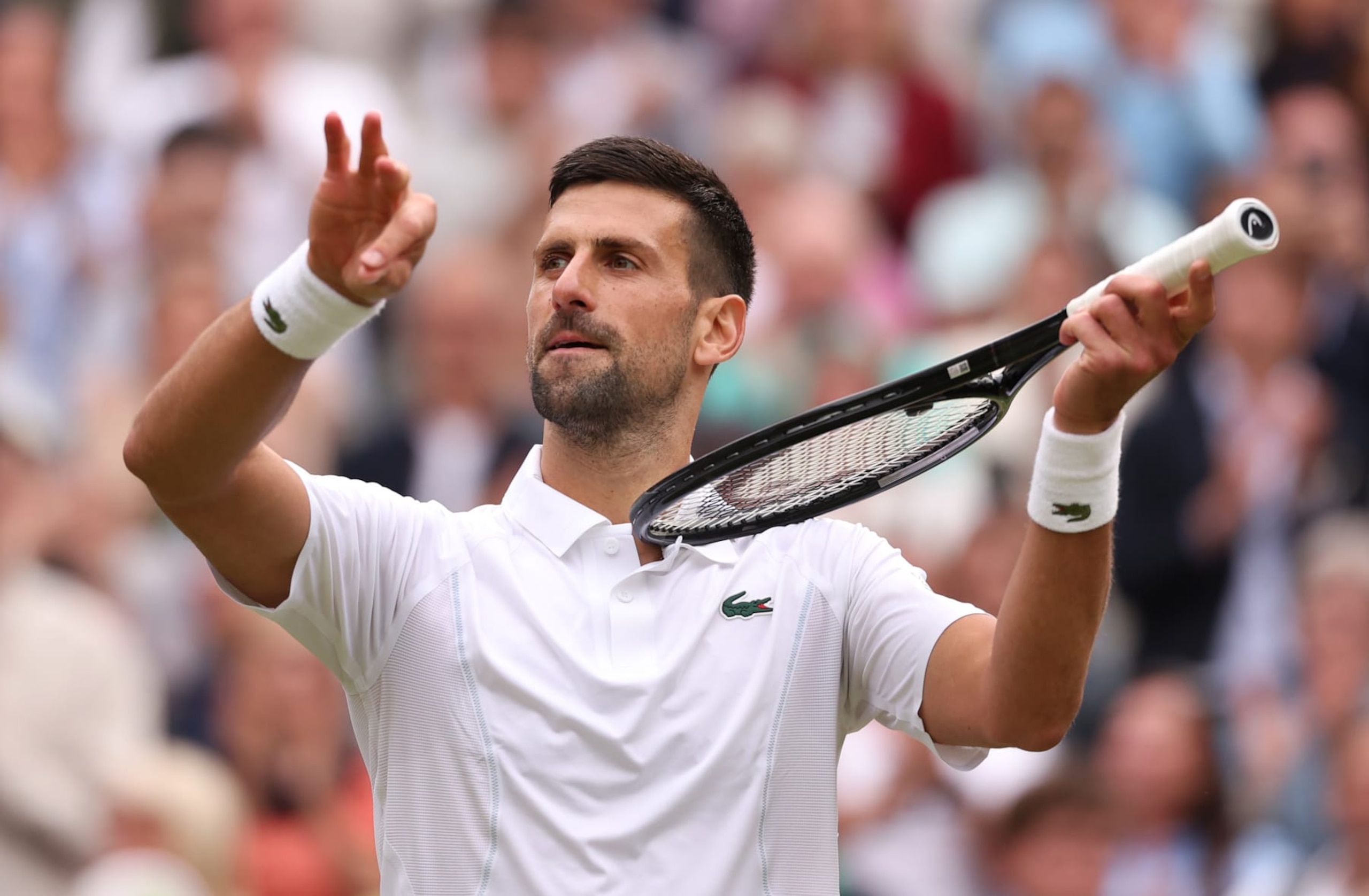 LONDON, ENGLAND - JULY 12: Novak Djokovic of Serbia celebrates winning match point with a violin gesture against Lorenzo Musetti of Italy in the Gentlemen's Singles Semi-Final match during day twelve of The Championships Wimbledon 2024 at All England Lawn Tennis and Croquet Club on July 12, 2024 in London, England. (Photo by Julian Finney/Getty Images)