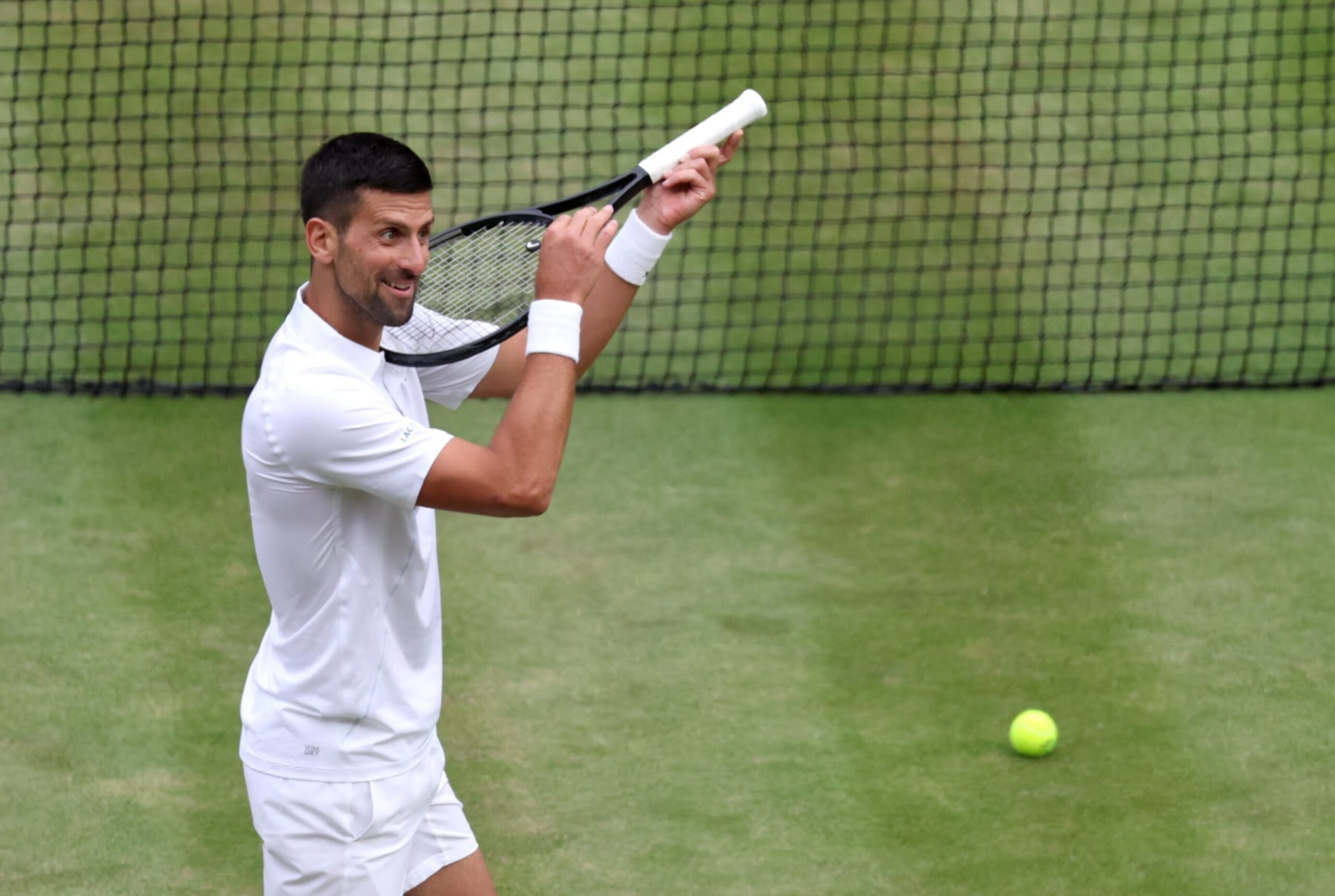 LONDON, ENGLAND - JULY 12: Novak Djokovic of Serbia celebrates winning match point, with a violin gesture, against Lorenzo Musetti of Italy in the Gentlemen's Singles Semi-Final match during day twelve of The Championships Wimbledon 2024 at All England Lawn Tennis and Croquet Club on July 12, 2024 in London, England. (Photo by Clive Brunskill/Getty Images)