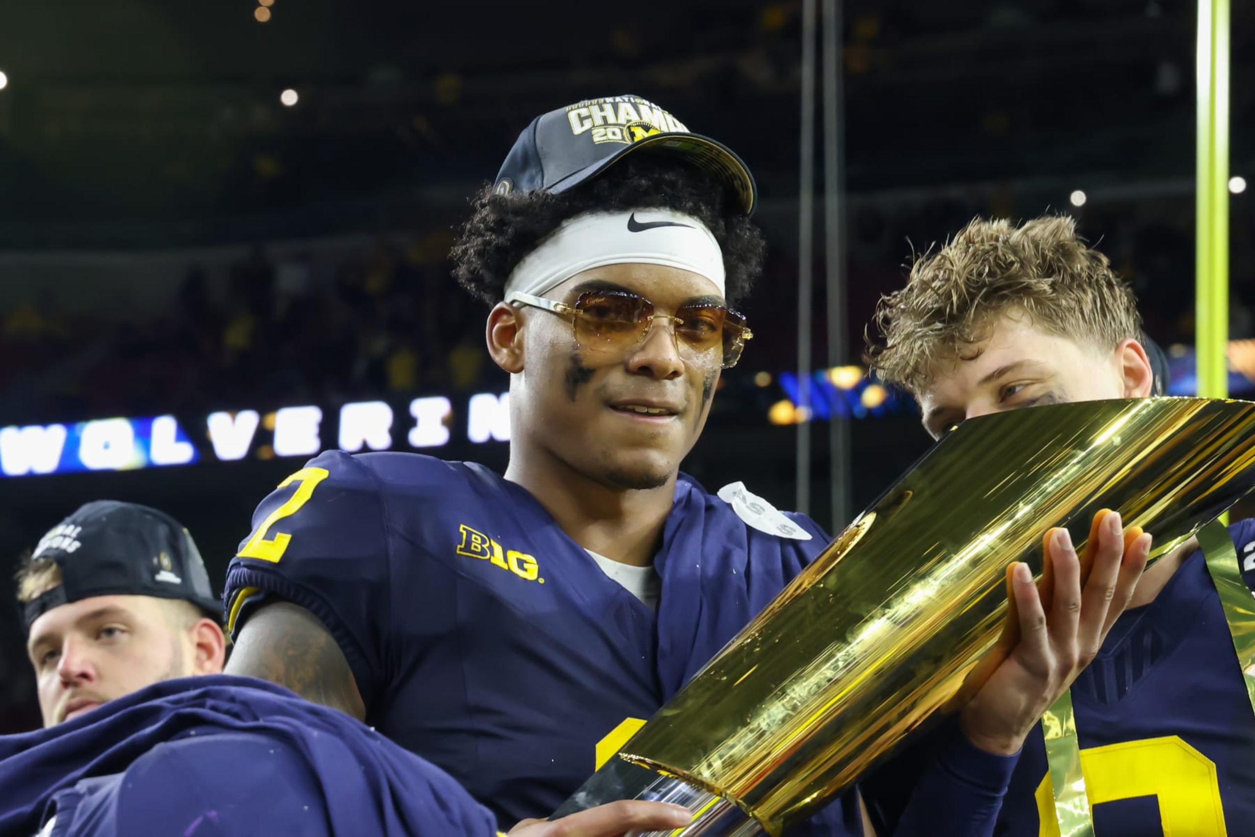 HOUSTON, TX - JANUARY 08: Michigan Wolverines defensive back Will Johnson (2) holds up the CFP trophy after winning the CFP National Championship game Michigan Wolverines and Washington Huskies on January 8, 2024, at NRG Stadium in Houston, Texas. (Photo by David Buono/Icon Sportswire via Getty Images)