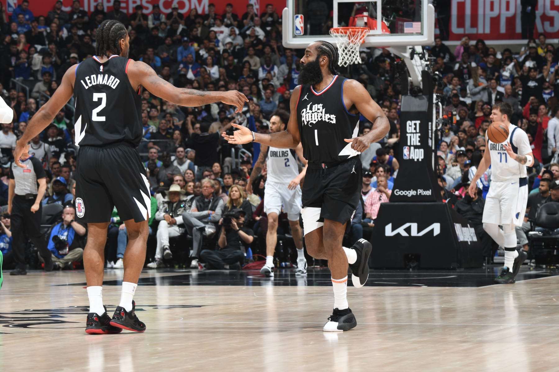 LOS ANGELES, CA - APRIL 23: James Harden #1 high fives Kawhi Leonard #2 of the LA Clippers during the game against the Dallas Mavericks during Round 1 Game 2 of the 2024 NBA Playoffs on April 23, 2024 at Crypto.Com Arena in Los Angeles, California. NOTE TO USER: User expressly acknowledges and agrees that, by downloading and/or using this Photograph, user is consenting to the terms and conditions of the Getty Images License Agreement. Mandatory Copyright Notice: Copyright 2024 NBAE (Photo by Andrew D. Bernstein/NBAE via Getty Images)