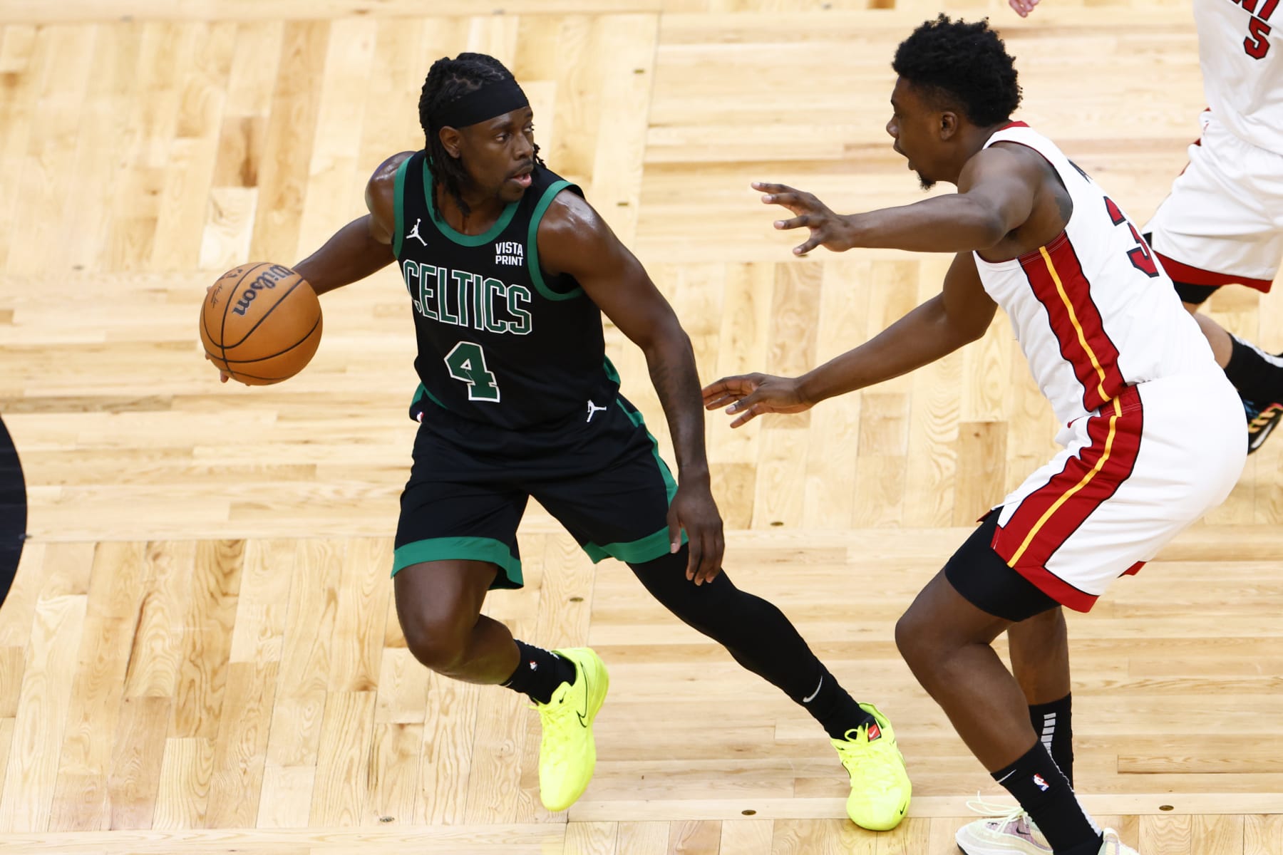 Boston, MA - May 1: Boston Celtics guard Jrue Holiday dribbles with pressure from Miami Heat center Thomas Bryant in the fourth quarter. (Photo by Danielle Parhizkaran/The Boston Globe via Getty Images)