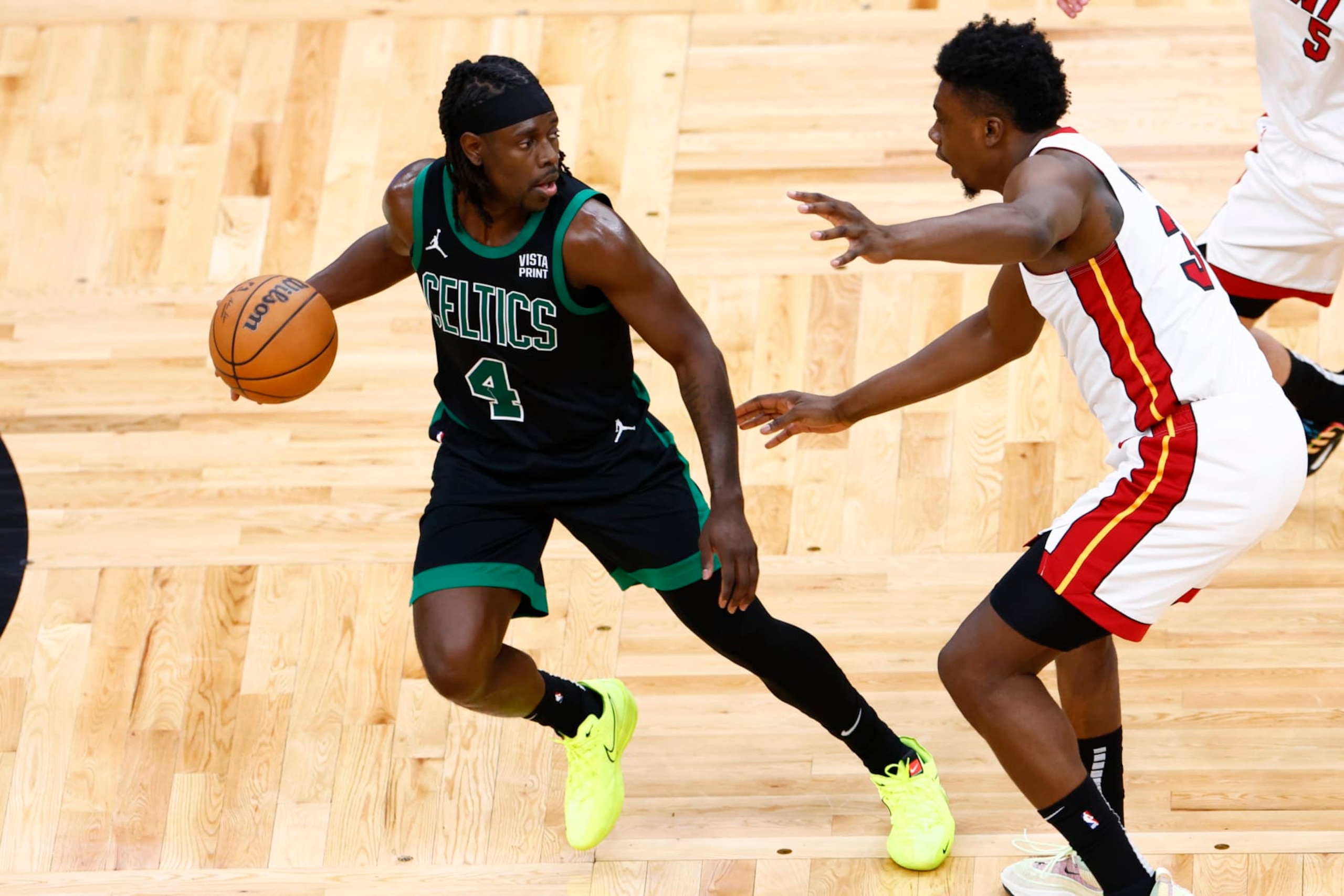 Boston, MA - May 1: Boston Celtics guard Jrue Holiday dribbles with pressure from Miami Heat center Thomas Bryant in the fourth quarter. (Photo by Danielle Parhizkaran/The Boston Globe via Getty Images) Boston, MA - May 1: Boston Celtics guard Jrue Holiday dribbles with pressure from Miami Heat center Thomas Bryant in the fourth quarter. (Photo by Danielle Parhizkaran/The Boston Globe via Getty Images)