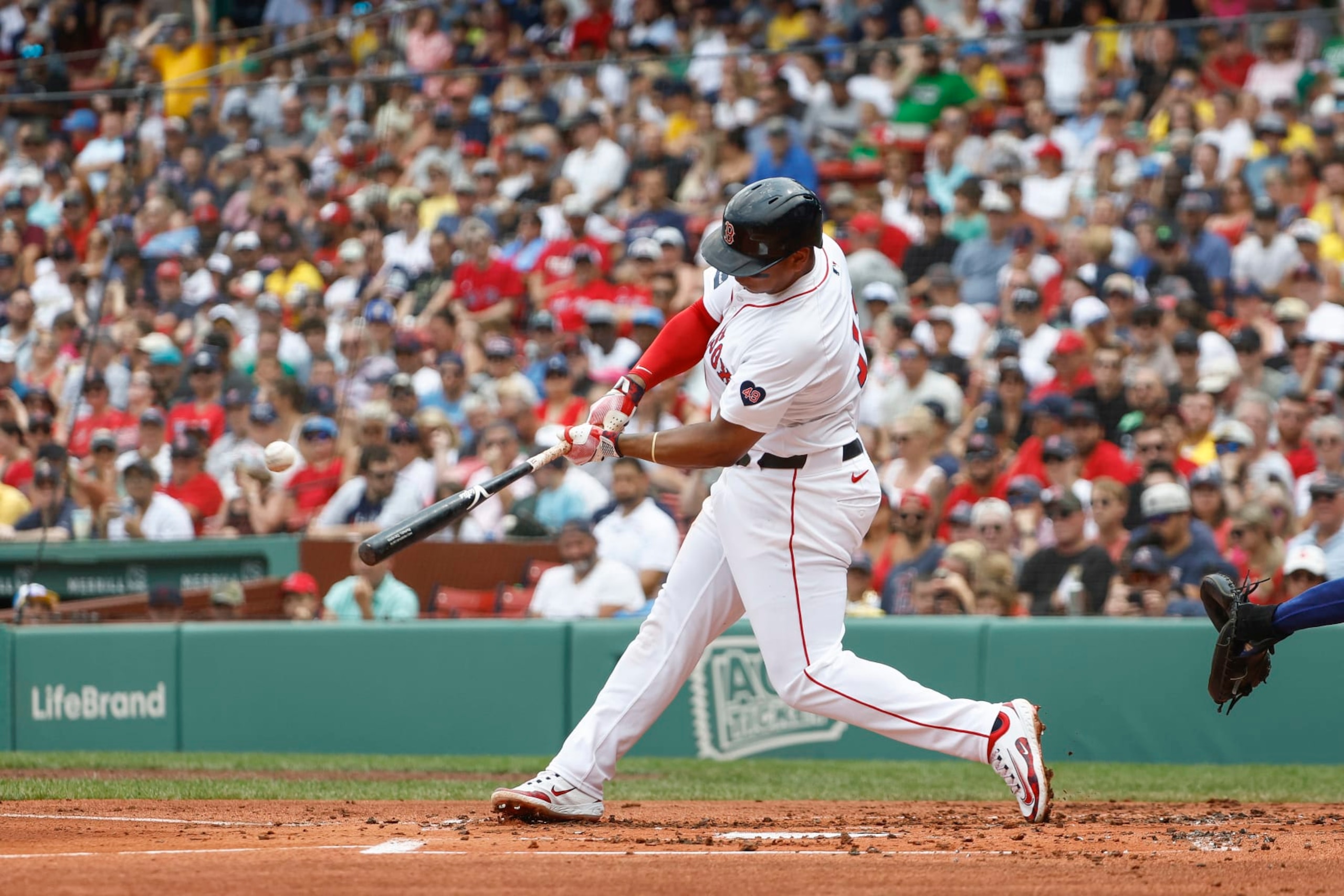 BOSTON, MA - JULY 14: Rafael Devers #11 of the Boston Red Sox connects on a two-run home run against the Kansas City Royals during the first inning at Fenway Park on July 14, 2024 in Boston, Massachusetts. (Photo By Winslow Townson/Getty Images)