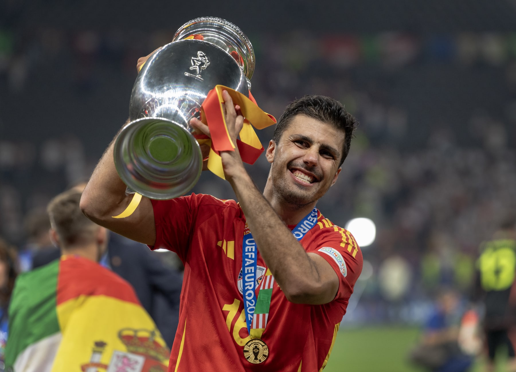 BERLIN, GERMANY - JULY 14: Rodri of Spain celebrates with the trophy after the UEFA EURO 2024 final match between Spain and England at Olympiastadion on July 14, 2024 in Berlin, Germany. (Photo by Visionhaus/Getty Images)