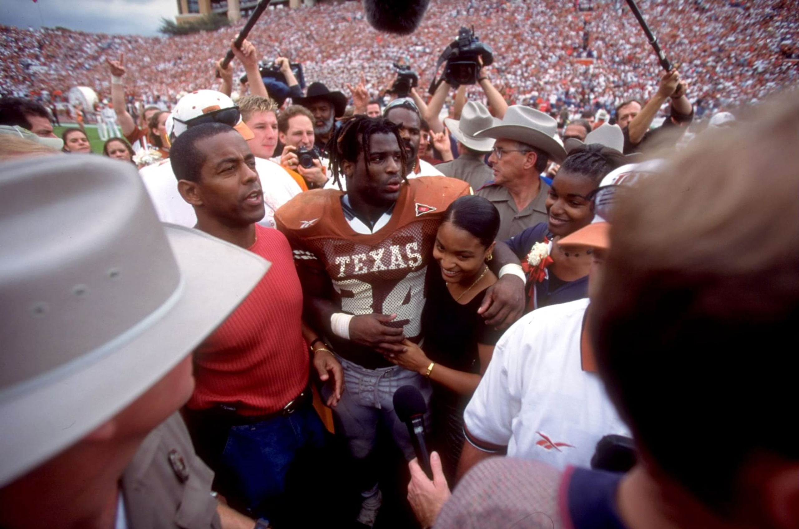 College Football: Texas Ricky Williams (34) walking off field hugging sister and with former Dallas Cowboys Tony Dorsett after game vs Texas A&M at Darrell K RoyalTexas Memorial Stadium. Williams breaks Dorsett's 22 year old NCAA career rushing record. Williams' final college game.
Austin, TX 11/27/1998
CREDIT: Bob Rosato (Photo by Bob Rosato /Sports Illustrated via Getty Images)
(Set Number: X56873 ) College Football: Texas Ricky Williams (34) walking off field hugging sister and with former Dallas Cowboys Tony Dorsett after game vs Texas A&M at Darrell K RoyalTexas Memorial Stadium. Williams breaks Dorsett's 22 year old NCAA career rushing record. Williams' final college game.
Austin, TX 11/27/1998
CREDIT: Bob Rosato (Photo by Bob Rosato /Sports Illustrated via Getty Images)
(Set Number: X56873 )