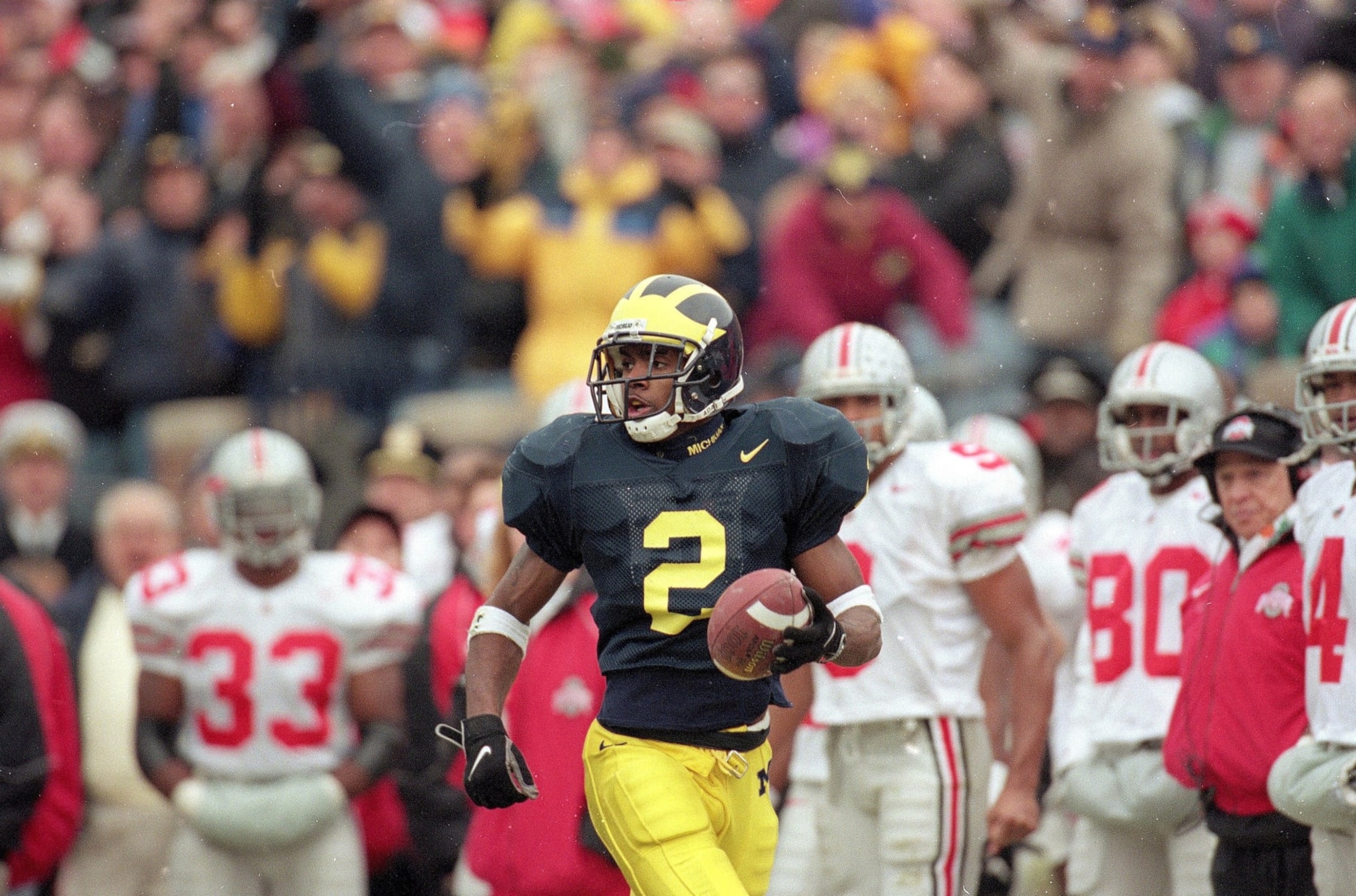 UNITED STATES - NOVEMBER 22: College Football: Michigan Charles Woodson (2) in action, returning punt for touchdown vs Ohio State, Ann Arbor, MI 11/22/1997 (Photo by Damian Strohmeyer/Sports Illustrated via Getty Images) (SetNumber: X53981 TK2 R9 F24) UNITED STATES - NOVEMBER 22: College Football: Michigan Charles Woodson (2) in action, returning punt for touchdown vs Ohio State, Ann Arbor, MI 11/22/1997 (Photo by Damian Strohmeyer/Sports Illustrated via Getty Images) (SetNumber: X53981 TK2 R9 F24)