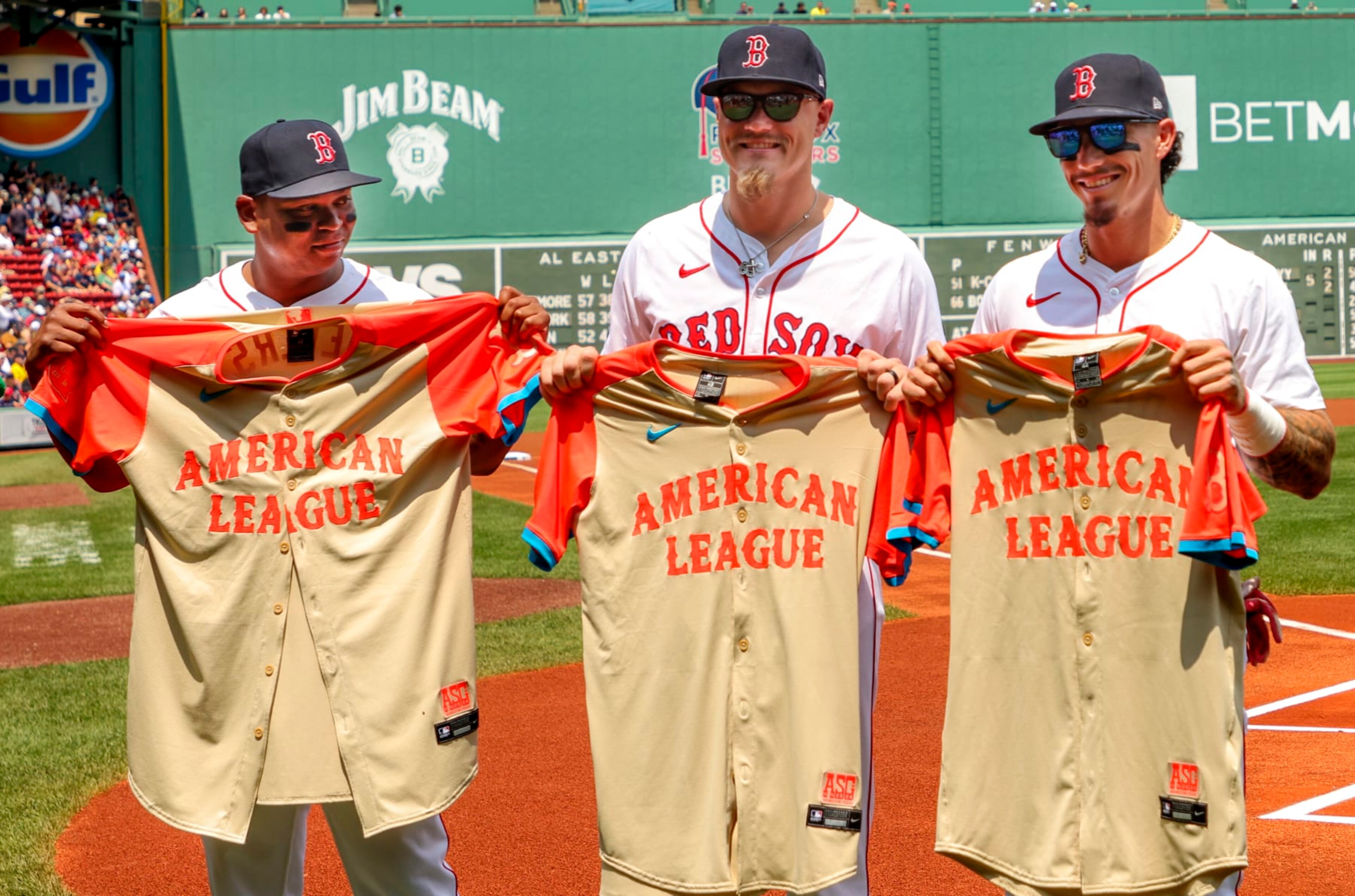 Boston, MA - July 14: From left, Boston Red Sox players selected to the 2024 All-Star Game, Rafael Devers, Tanner Houck, and Jarren Duran, pose with their jerseys. (Photo by Matthew J. Lee/The Boston Globe via Getty Images)