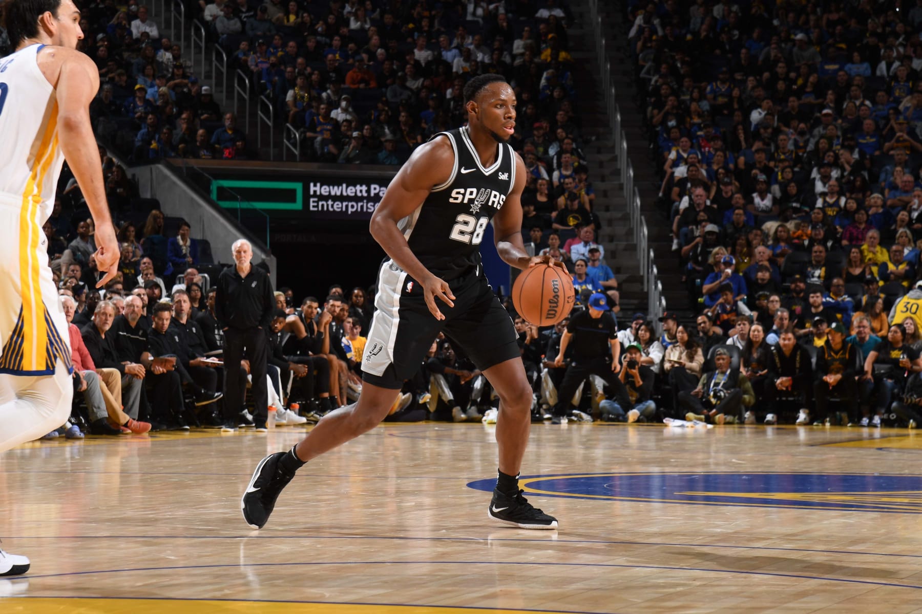 SAN FRANCISCO, CA - OCTOBER 20: Charles Bassey #28 of the San Antonio Spurs dribbles the ball during the game against the Golden State Warriors on October 20, 2023 at Chase Center in San Francisco, California. NOTE TO USER: User expressly acknowledges and agrees that, by downloading and or using this photograph, user is consenting to the terms and conditions of Getty Images License Agreement. Mandatory Copyright Notice: Copyright 2023 NBAE (Photo by Noah Graham/NBAE via Getty Images)
