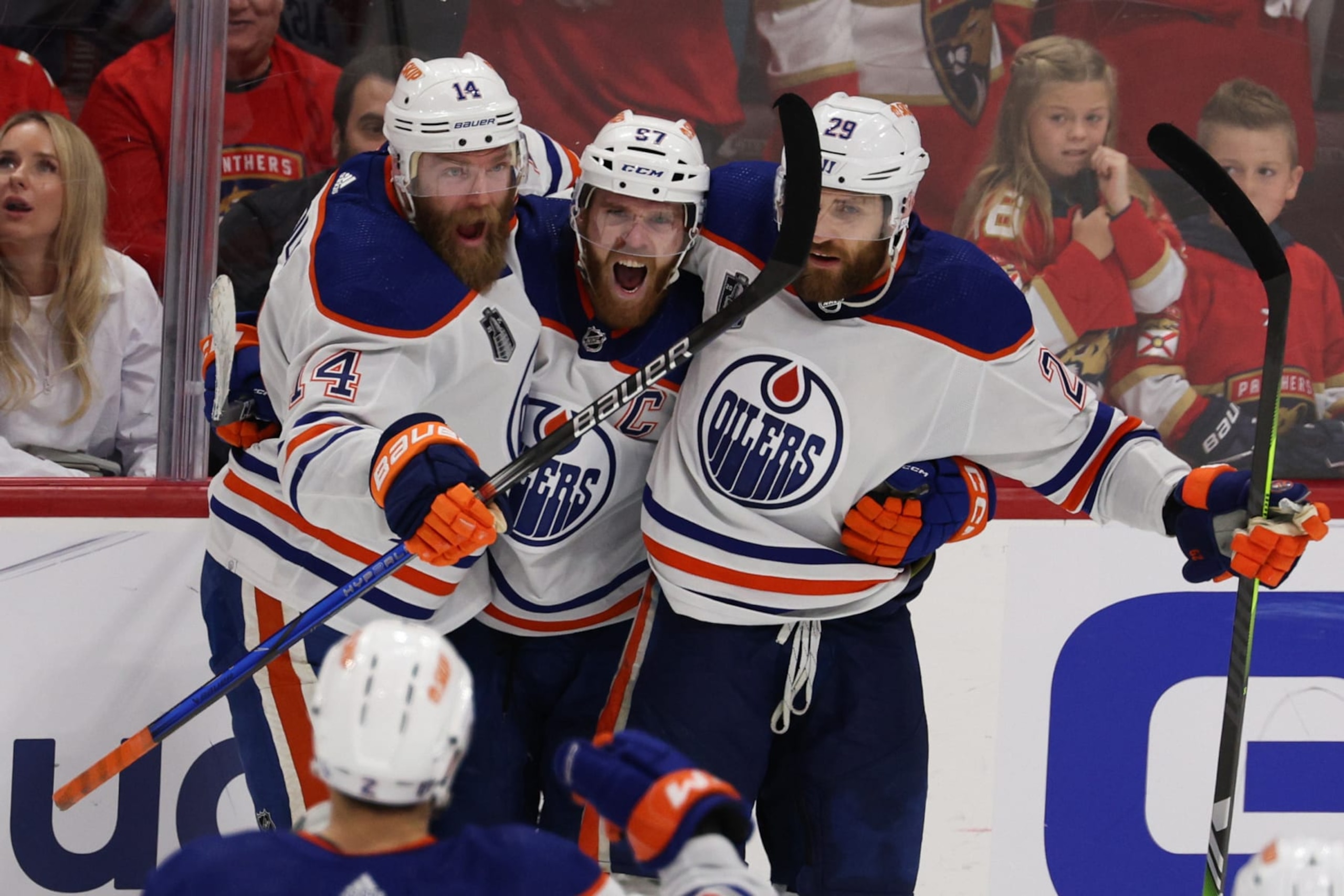 SUNRISE, FLORIDA - JUNE 18: Connor McDavid #97 of the Edmonton Oilers celebrates with teammates after scoring during the third period against the Florida Panthers in Game Five of the 2024 Stanley Cup Final at Amerant Bank Arena on June 18, 2024 in Sunrise, Florida.  (Photo by Elsa/Getty Images)