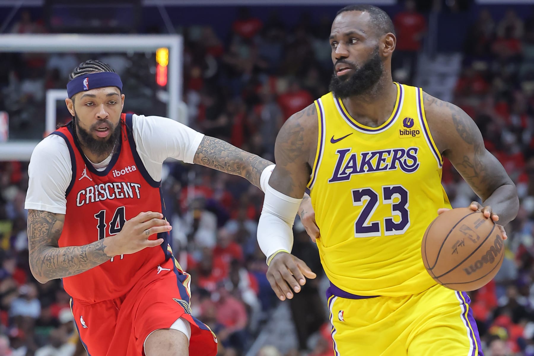 NEW ORLEANS, LOUISIANA - APRIL 16: LeBron James #23 of the Los Angeles Lakers drives against Brandon Ingram #14 of the New Orleans Pelicans during the second half of a play-in tournament game at the Smoothie King Center on April 16, 2024 in New Orleans, Louisiana. NOTE TO USER: User expressly acknowledges and agrees that, by downloading and or using this Photograph, user is consenting to the terms and conditions of the Getty Images License Agreement. (Photo by Jonathan Bachman/Getty Images)