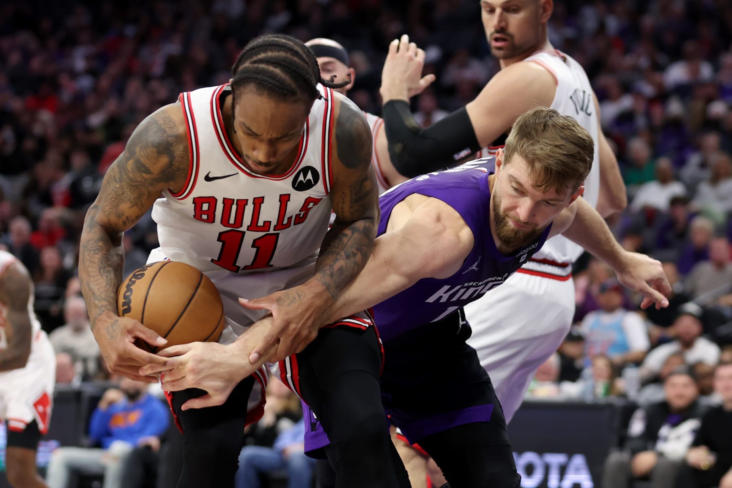 SACRAMENTO, CALIFORNIA - MARCH 04: DeMar DeRozan #11 of the Chicago Bulls and Domantas Sabonis #10 of the Sacramento Kings go for a loose ball in the second half at Golden 1 Center on March 04, 2024 in Sacramento, California. NOTE TO USER: User expressly acknowledges and agrees that, by downloading and or using this photograph, User is consenting to the terms and conditions of the Getty Images License Agreement.  (Photo by Ezra Shaw/Getty Images)