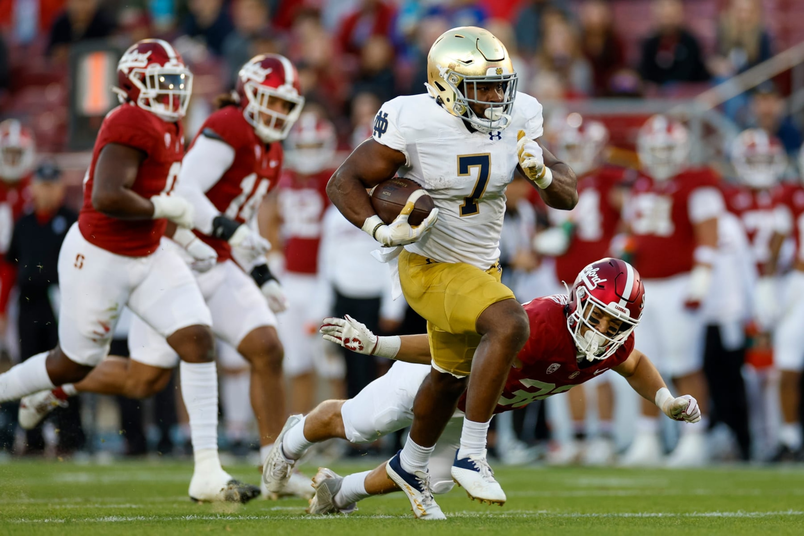 STANFORD, CALIFORNIA - NOVEMBER 25: Audric Estime #7 of the Notre Dame Fighting Irish runs with the ball in the first half during a game against the Stanford Cardinal at Stanford Stadium on November 25, 2023 in Stanford, California. (Photo by Brandon Sloter/Image Of Sport/Getty Images)