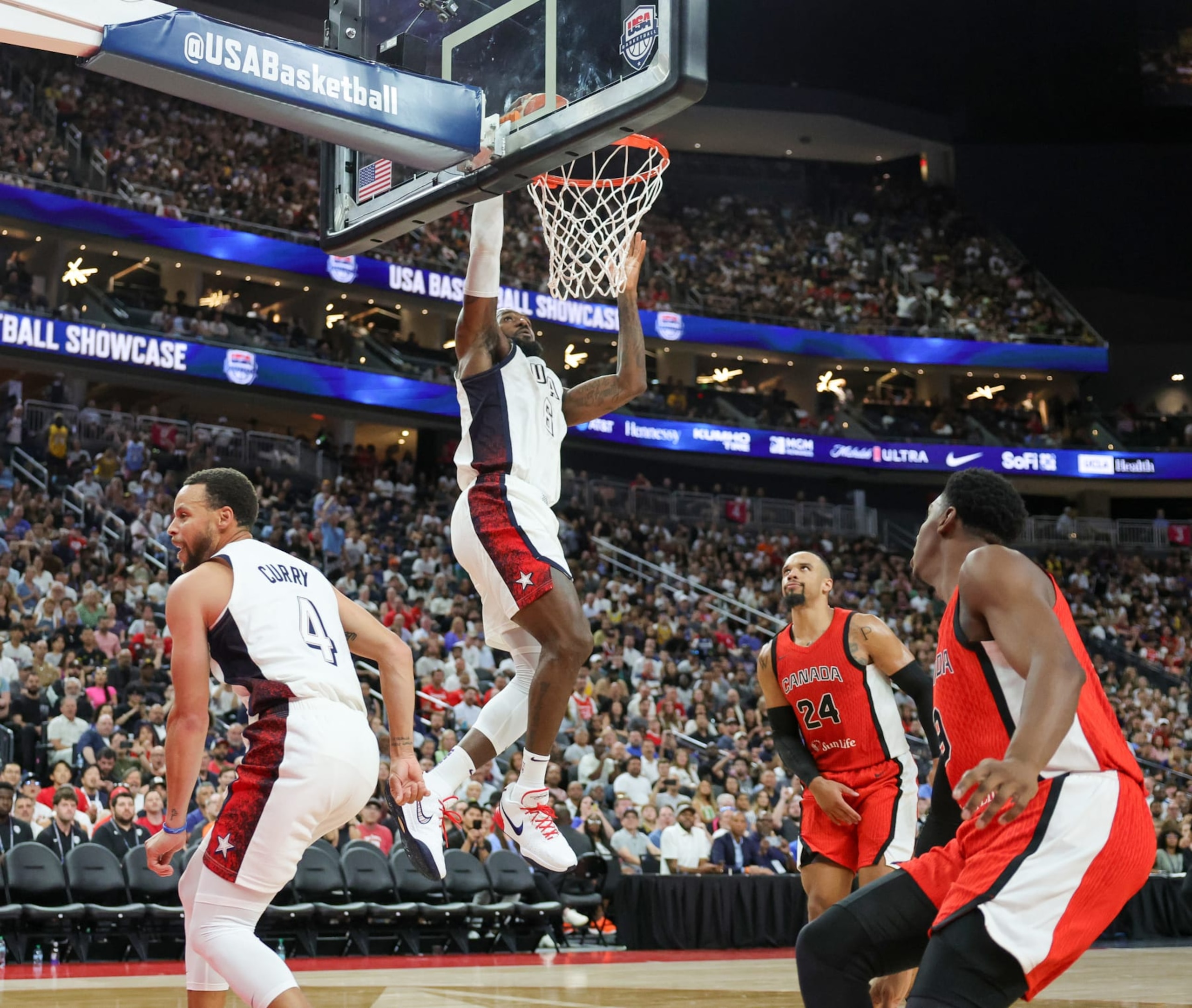 LAS VEGAS, NEVADA - JULY 10: LeBron James #6 of the United States dunks ahead of Dillon Brooks #24 and RJ Barrett #9 of Canada off of an alley-oop pass from Stephen Curry #4 in the second half of their exhibition game ahead of the Paris Olympic Games at T-Mobile Arena on July 10, 2024 in Las Vegas, Nevada. The United States defeated Canada 86-72. (Photo by Ethan Miller/Getty Images)