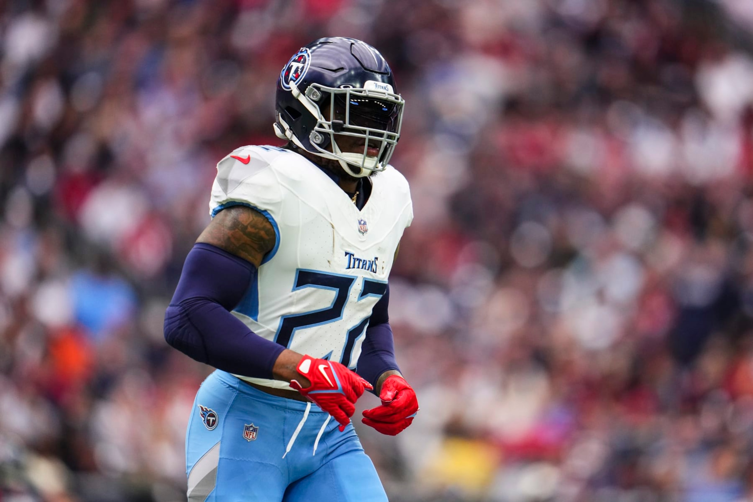 HOUSTON, TX - DECEMBER 31: Derrick Henry #22 of the Tennessee Titans looks on from the field during an NFL football game against the Houston Texans at NRG Stadium on December 31, 2023 in Houston, Texas. (Photo by Cooper Neill/Getty Images)