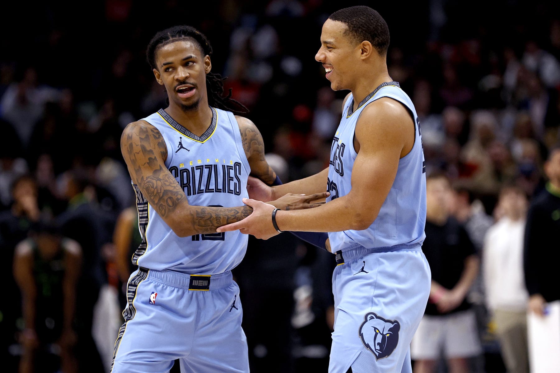 NEW ORLEANS, LOUISIANA - DECEMBER 26: Ja Morant #12 of the Memphis Grizzlies reacts with Desmond Bane #22 of the Memphis Grizzlies during overtime of an NBA game against the New Orleans Pelicans at Smoothie King Center on December 26, 2023 in New Orleans, Louisiana. The Memphis Grizzlies won the game 116 - 115 over the New Orleans Pelicans. NOTE TO USER: User expressly acknowledges and agrees that, by downloading and or using this photograph, User is consenting to the terms and conditions of the Getty Images License Agreement. (Photo by Sean Gardner/Getty Images)