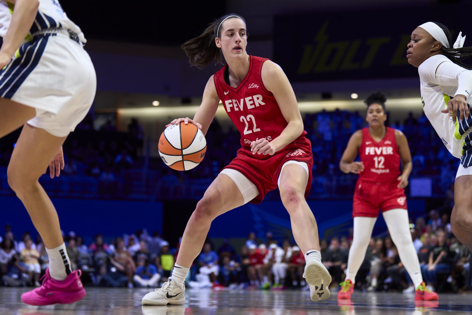 ARLINGTON, TEXAS - JULY 17: Caitlin Clark #22 of the Indiana Fever drives to the basket against the Dallas Wings at the College Park Center on July 17, 2024 in Arlington, Texas. NOTE TO USER: User expressly acknowledges and agrees that, by downloading and or using this photograph, User is consenting to the terms and conditions of the Getty Images License Agreement.  (Photo by Cooper Neill/Getty Images)