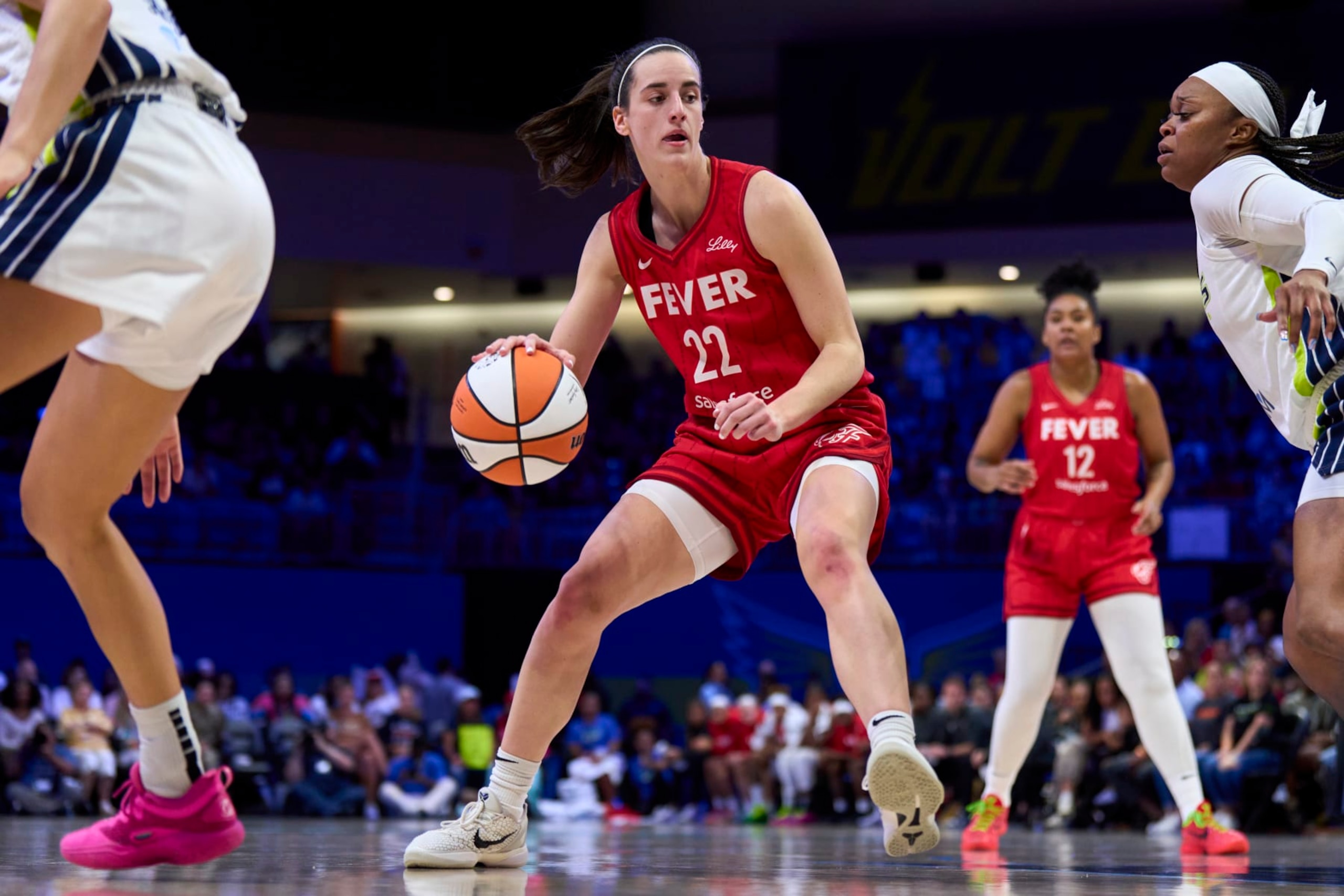 ARLINGTON, TEXAS - JULY 17: Caitlin Clark #22 of the Indiana Fever drives to the basket against the Dallas Wings at the College Park Center on July 17, 2024 in Arlington, Texas. NOTE TO USER: User expressly acknowledges and agrees that, by downloading and or using this photograph, User is consenting to the terms and conditions of the Getty Images License Agreement.  (Photo by Cooper Neill/Getty Images)