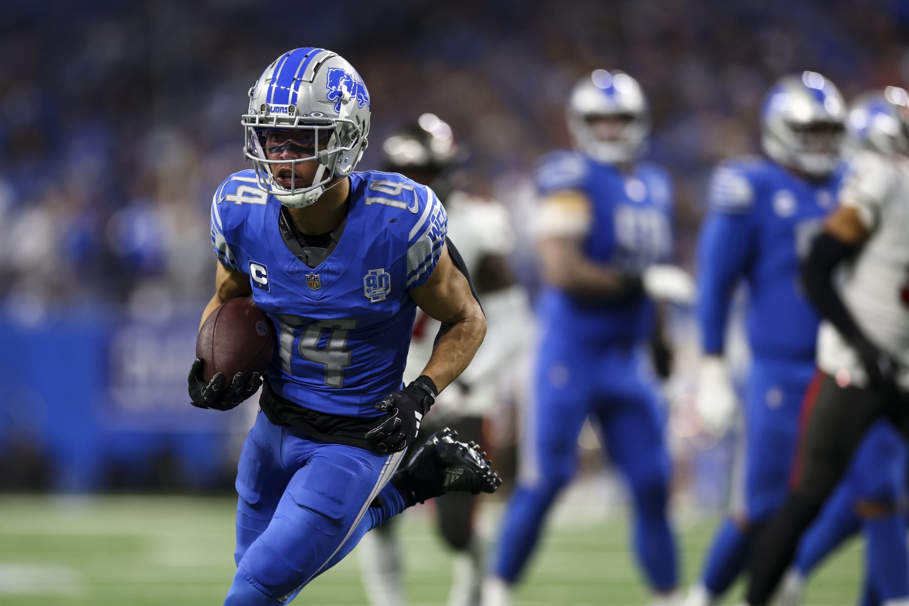 DETROIT, MI - JANUARY 21: Amon-Ra St. Brown #14 of the Detroit Lions carries the ball during the third quarter of an NFL divisional round playoff football game against the Tampa Bay Buccaneers at Ford Field on January 21, 2024 in Detroit, Michigan. (Photo by Kevin Sabitus/Getty Images)