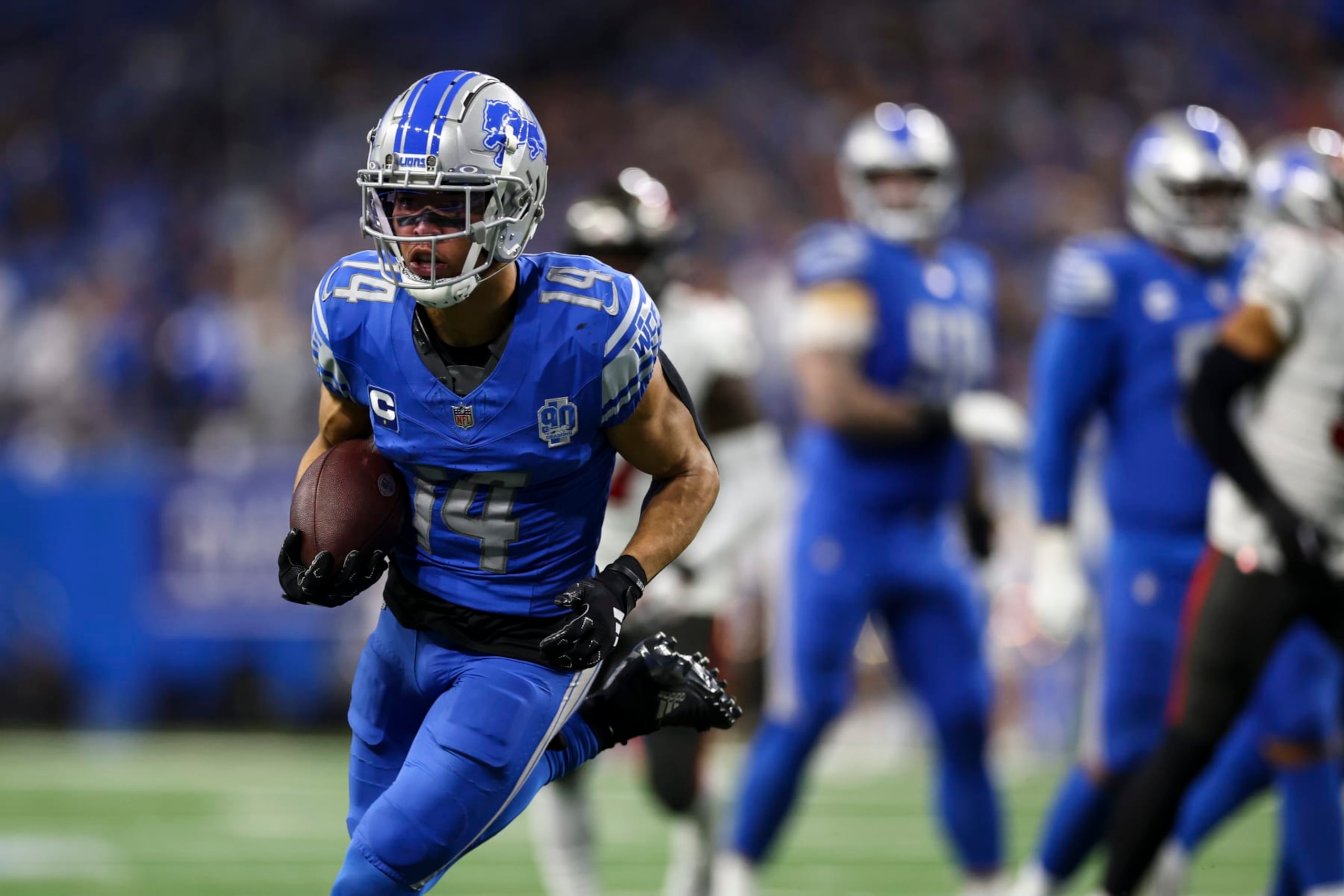DETROIT, MI - JANUARY 21: Amon-Ra St. Brown #14 of the Detroit Lions carries the ball during the third quarter of an NFL divisional round playoff football game against the Tampa Bay Buccaneers at Ford Field on January 21, 2024 in Detroit, Michigan. (Photo by Kevin Sabitus/Getty Images)