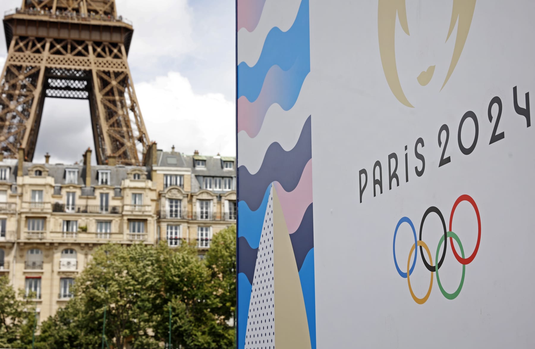 PARIS, FRANCE - JUNE 17: The Paris 2024 logo is displayed near the Eiffel Tower before the start of the Paris 2024 Olympic and Paralympic Games on June 17, 2024 in Paris, France. The city is gearing up to host the XXXIII Olympic Summer Games, from 26 July to 11 August. (Photo by Chesnot/Getty Images)