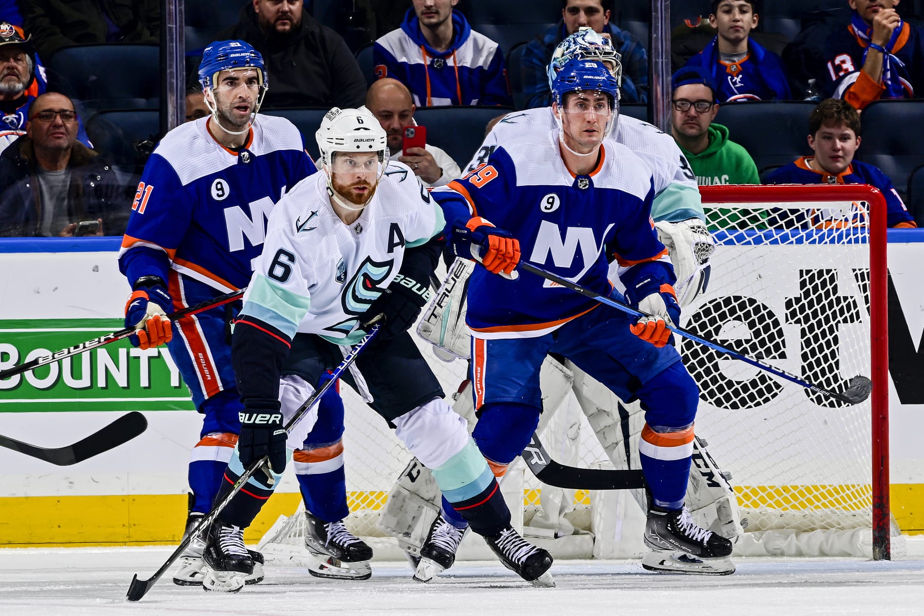 New York Islanders center Brock Nelson (right) and Seattle Kraken defenseman Adam Larsson. 