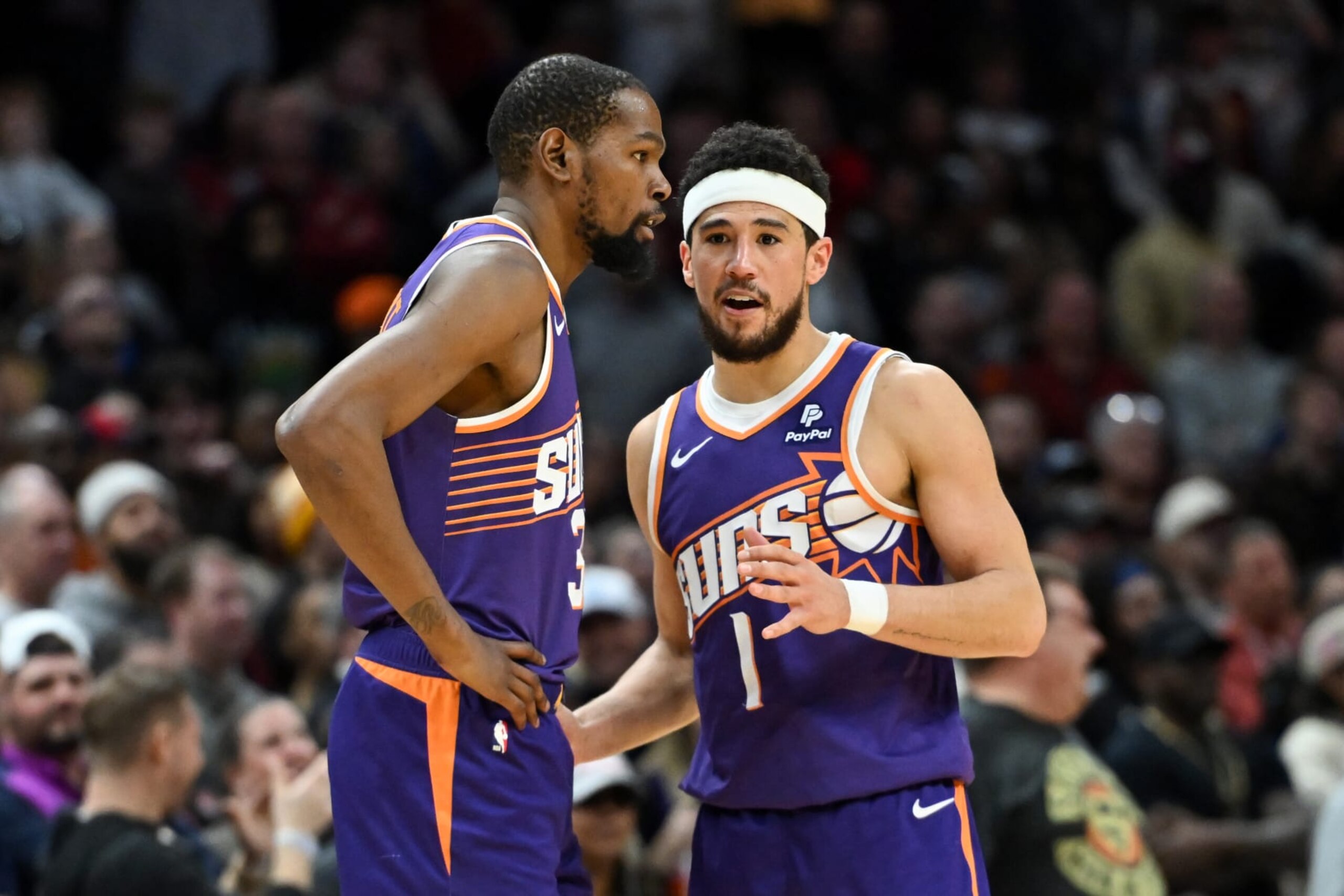 CLEVELAND, OHIO - MARCH 11: Devin Booker #1 of the Phoenix Suns talks with Kevin Durant #35 during the second half against the Cleveland Cavaliers at Rocket Mortgage Fieldhouse on March 11, 2024 in Cleveland, Ohio. NOTE TO USER: User expressly acknowledges and agrees that, by downloading and or using this photograph, User is consenting to the terms and conditions of the Getty Images License Agreement. (Photo by Nick Cammett/Getty Images)