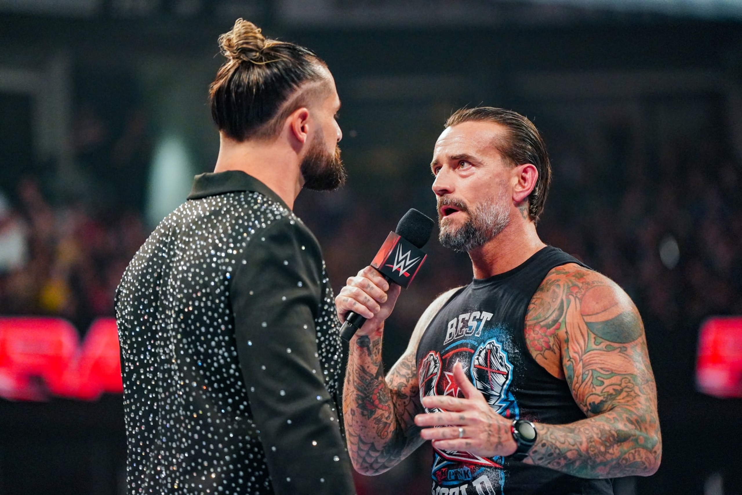 OTTAWA, CANADA - JULY 8: Seth Rollins and CM Punk have a chat in the ring during Monday Night RAW at Canadian Tire Centre on July 8, 2024 in Ottawa, Ontario.  (Photo by WWE/Getty Images)