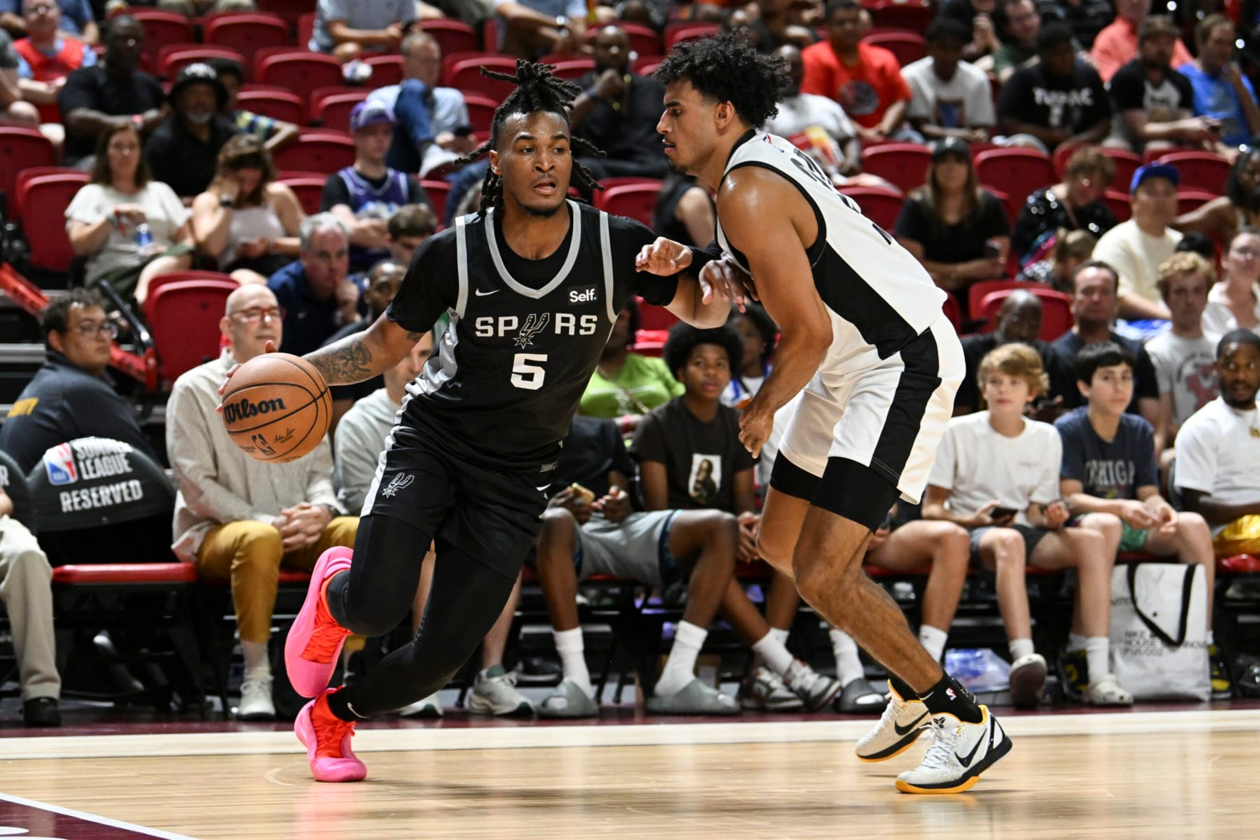 LAS VEGAS, NEVADA - JULY 13: Stephon Castle #5 of the San Antonio Spurs drives past Justin Minaya #24 of the Portland Trail Blazers in the second half of a 2024 NBA Summer League game at the Thomas & Mack Center on July 13, 2024 in Las Vegas, Nevada. The Spurs defeated the Trail Blazers 83-77. NOTE TO USER: User expressly acknowledges and agrees that, by downloading and or using this photograph, User is consenting to the terms and conditions of the Getty Images License Agreement. (Photo by Candice Ward/Getty Images)