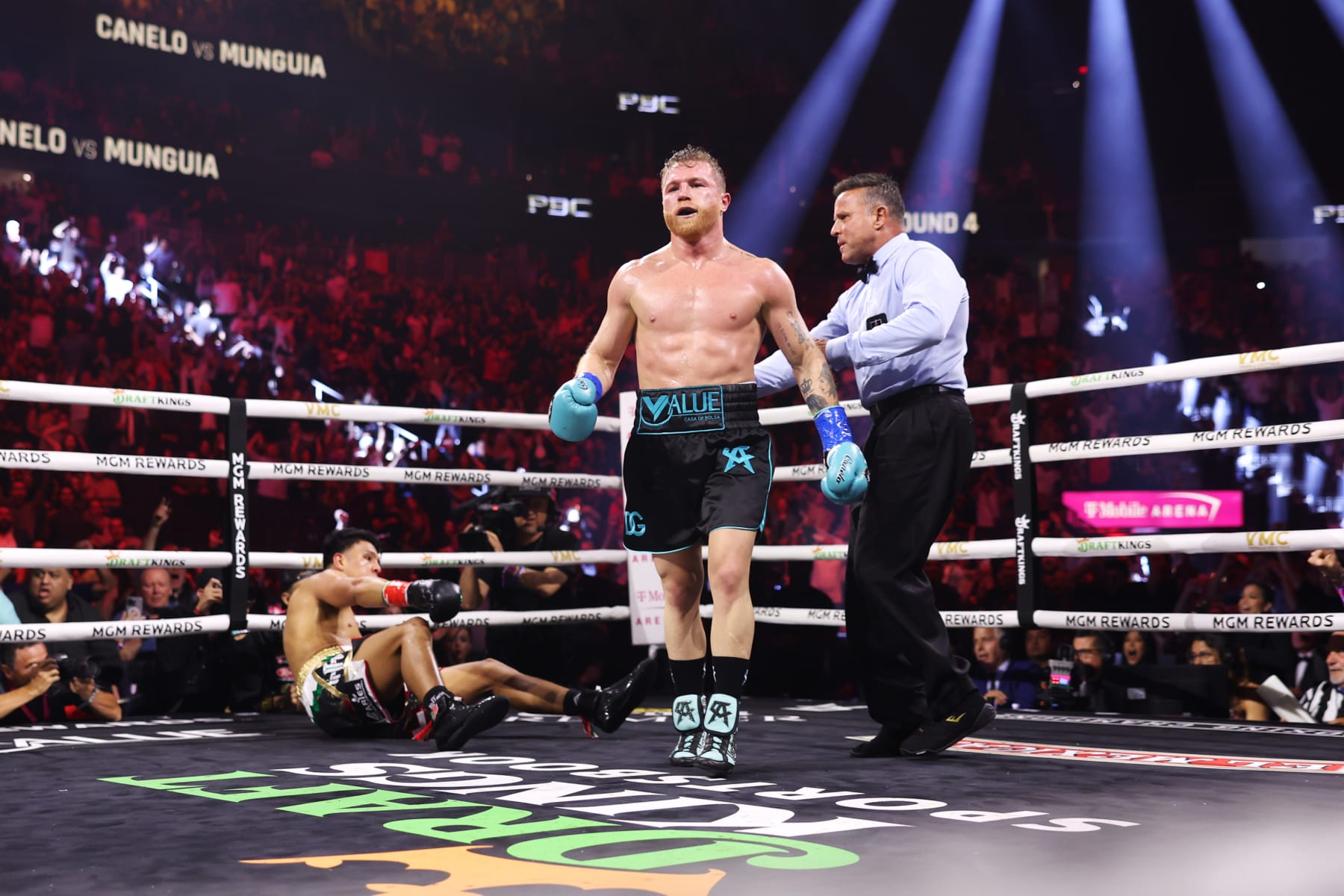 LAS VEGAS, NEVADA - MAY 04: Canelo Alvarez of Mexico (R) knocks down Jaime Munguia (L) during their super middleweight title fight at T-Mobile Arena on May 04, 2024 in Las Vegas, Nevada. (Photo by Cris Esqueda/Golden Boy/Getty Images)