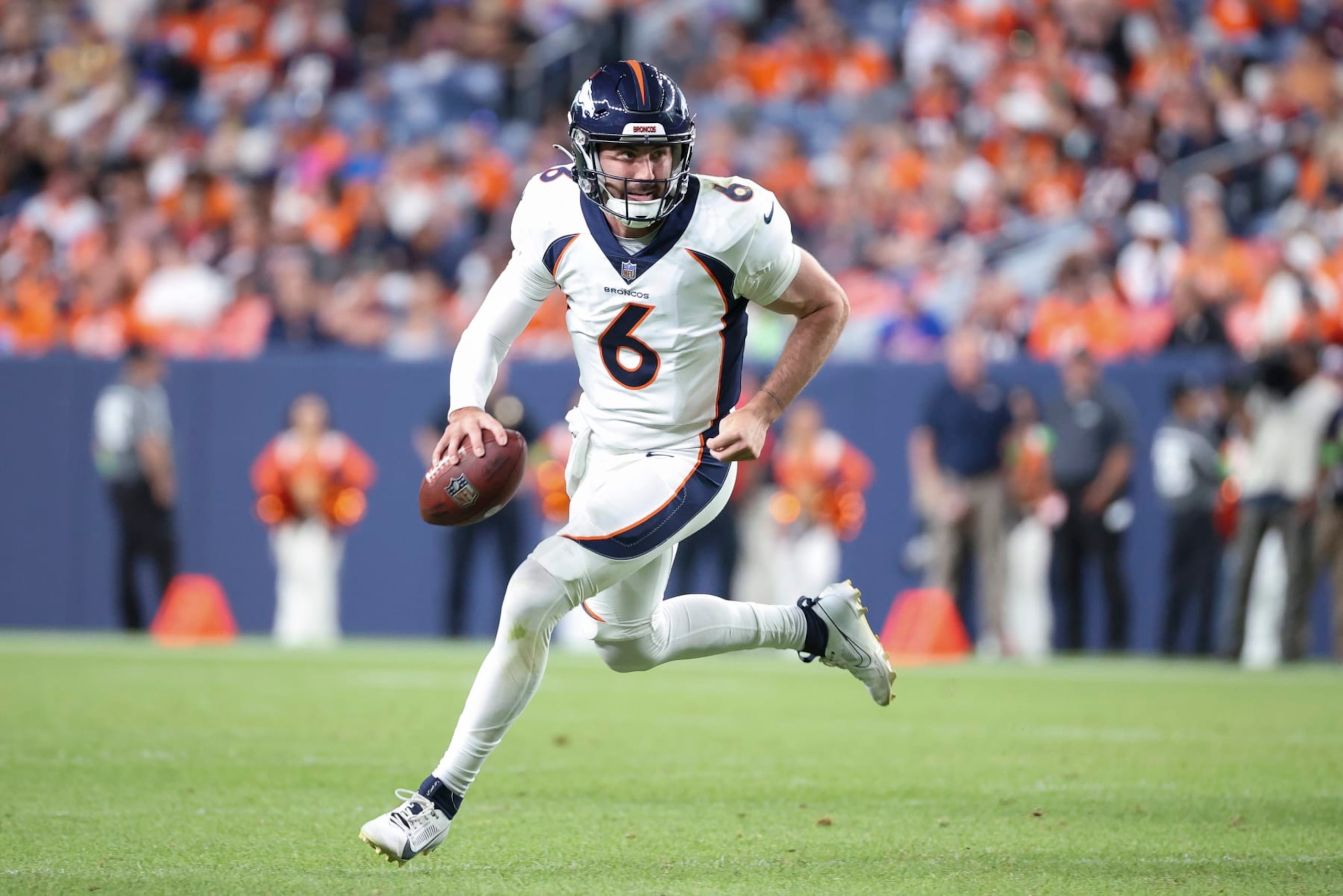 DENVER, COLORADO - AUGUST 26: Ben DiNucci #6 of the Denver Broncos scrambles in the second half of a preseason game against the Los Angeles Rams at Empower Field At Mile High on August 26, 2023 in Denver, Colorado. (Photo by Tyler Schank/Getty Images)