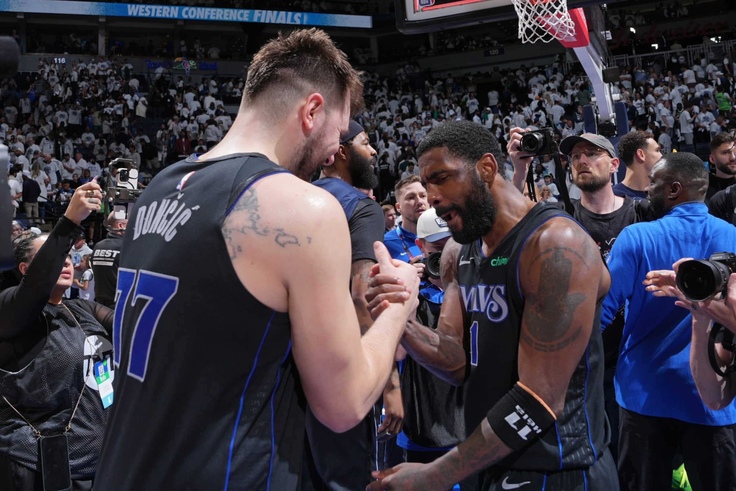 MINNEAPOLIS, MN -  MAY 24: Luka Doncic #77 and Kyrie Irving #11 of the Dallas Mavericks embrace after the game against the Minnesota Timberwolves during Game 2 of the Western Conference Finals of the 2024 NBA Playoffs on February 24, 2024 at Target Center in Minneapolis, Minnesota. NOTE TO USER: User expressly acknowledges and agrees that, by downloading and or using this Photograph, user is consenting to the terms and conditions of the Getty Images License Agreement. Mandatory Copyright Notice: Copyright 2024 NBAE (Photo by Jesse D. Garrabrant/NBAE via Getty Images)